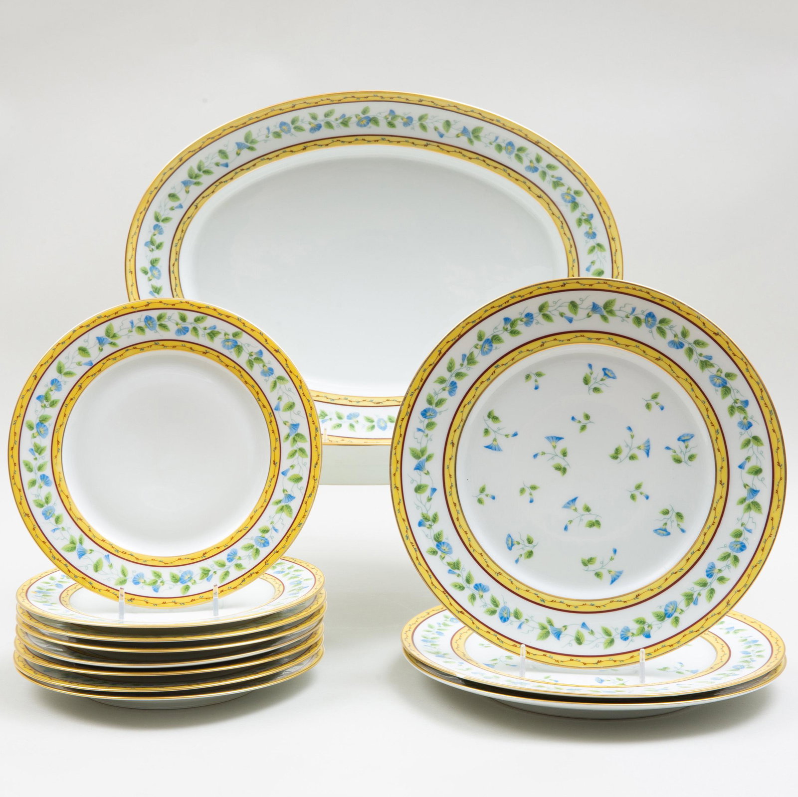 Raynaud Et Cie Limoges Porcelain Part Dinner Service in: Raynaud Et Cie Limoges Porcelain Part Dinner Service in the 'Morning Glory' Pattern Green and blue printed marks. Comprising: Two oval platters Eight salad Plates Three dinner plates The dinner plates