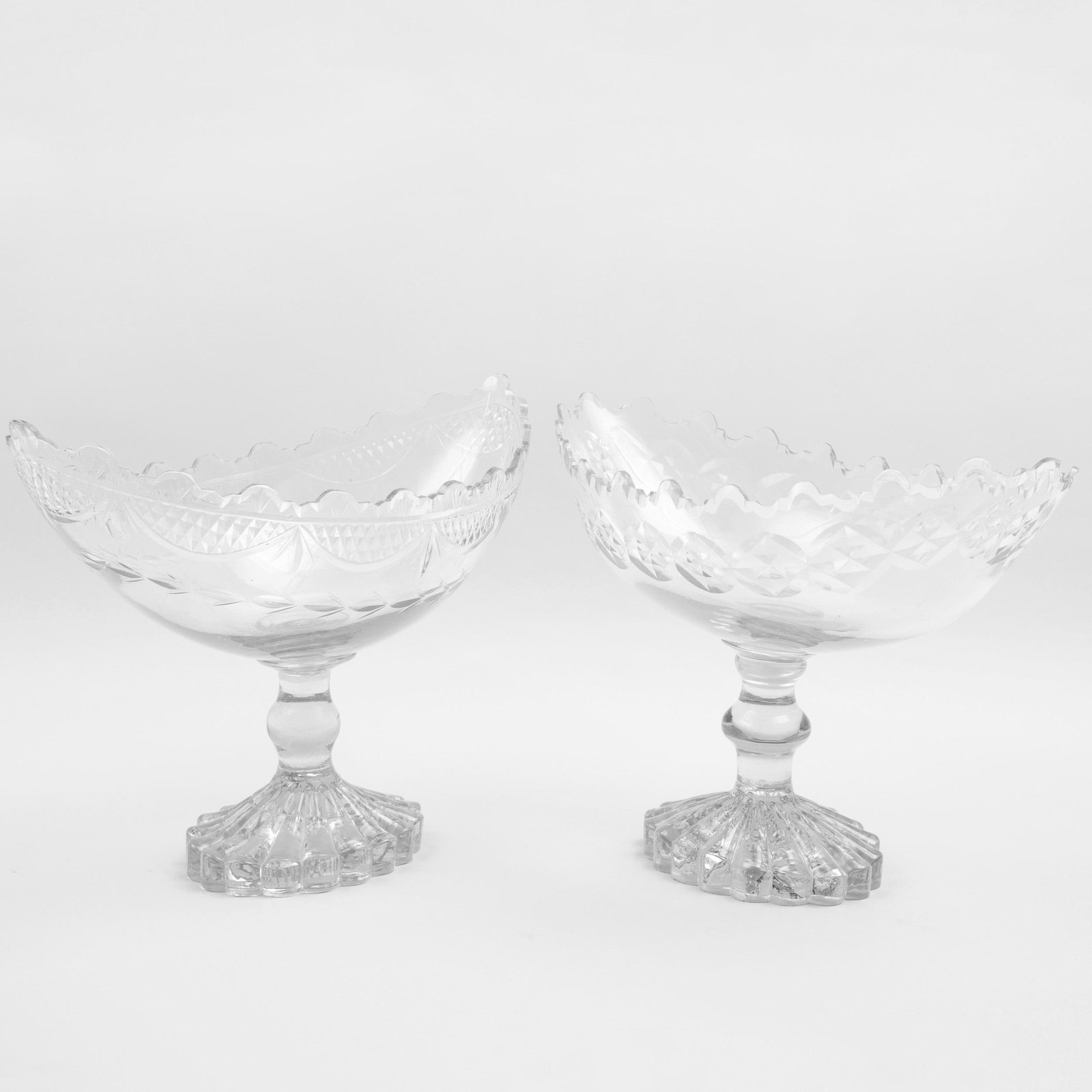 Two Similar Irish Glass Navette Form Centerpieces: Two Similar Irish Glass Navette Form Centerpieces The larger 11 x 14 3/4 x 8 1/8 in., the smaller 10 1/2 x 15 1/4 x 8 in. Selected Property from the Collection of Mr. and Mrs. Gutfreund