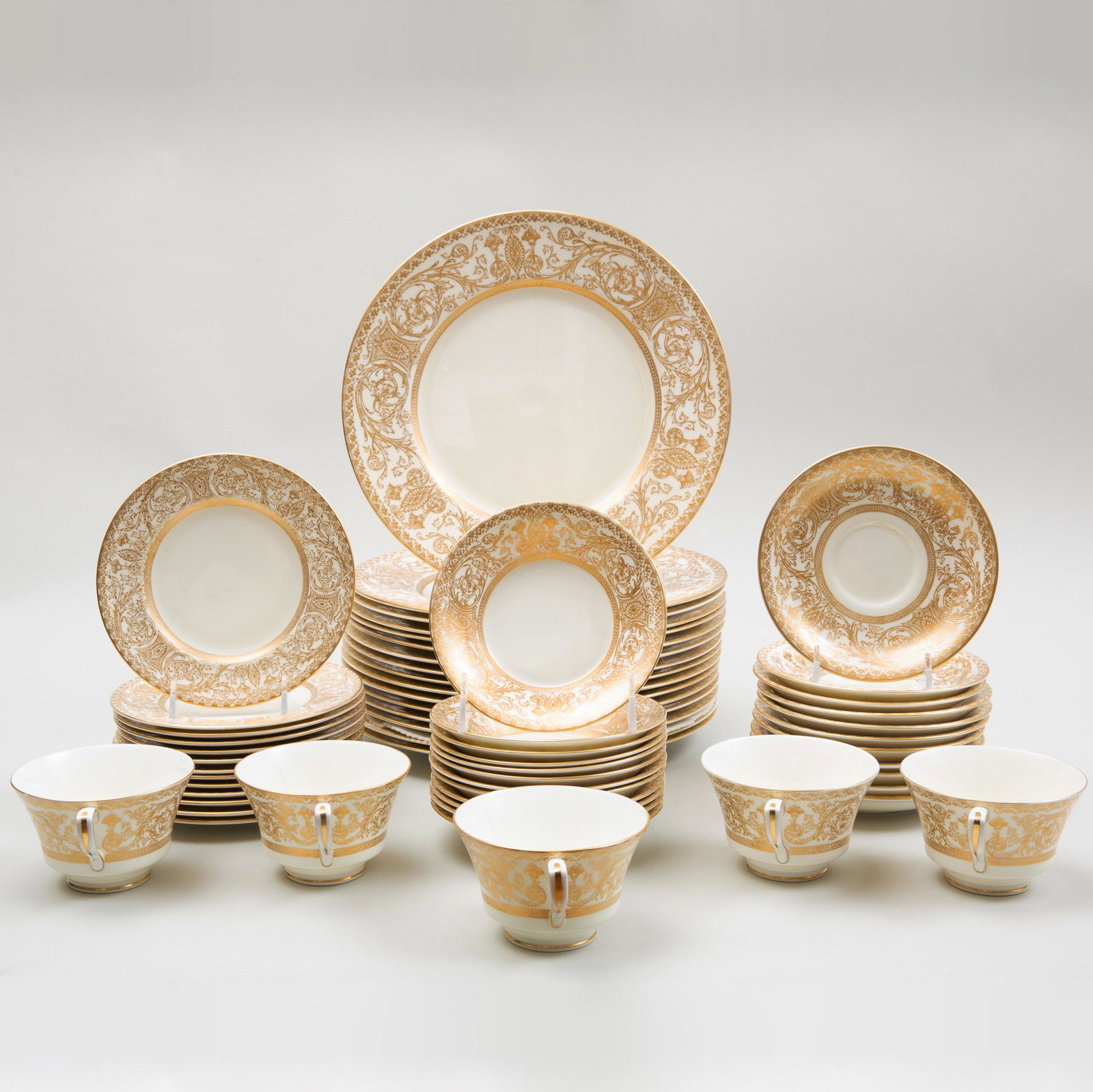 Royal Worcester Gilt-Decorated Porcelain Part Service: Royal Worcester Gilt-Decorated Porcelain Part Service in the 'Embassy' Pattern Black printed mark. Comprising: Sixteen dinner plates Thirteen dessert plates Twelve fruit bowls Five teacups and eleven 