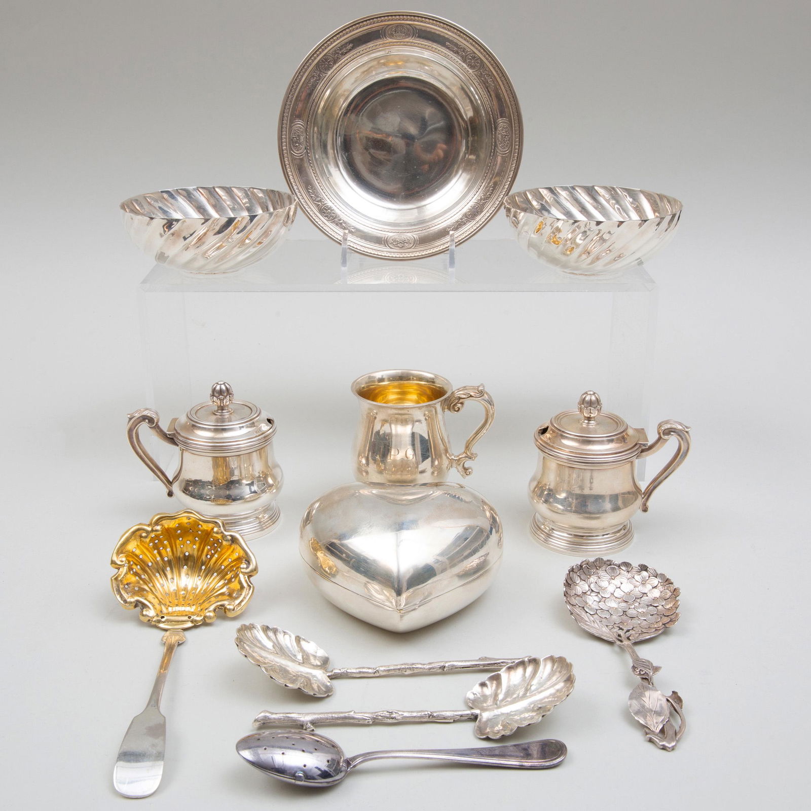 Group of Silver and Silver Plate Table Articles: Group of Silver and Silver Plate Table Articles The silver comprising: A spoon tea strainer, marked '.800' A wine coaster, marked, 'Sterling' A pair of Puiforcat mustart pots, marked '.950' A pair of