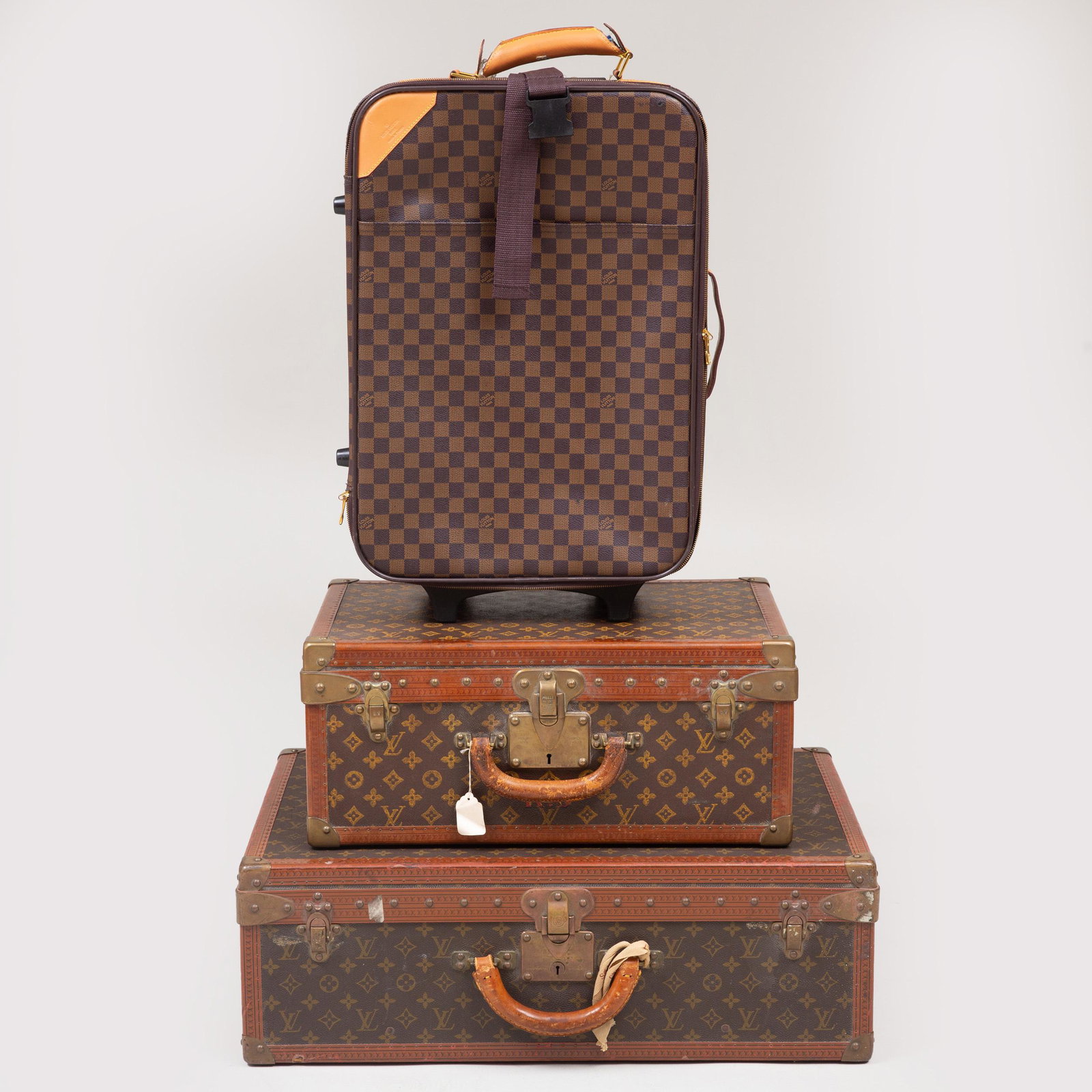 Two Vintage Louis Vuitton Hardcased Suitcases: Two Vintage Louis Vuitton Hardcased Suitcases Together with later reproduction roller bag. The lar