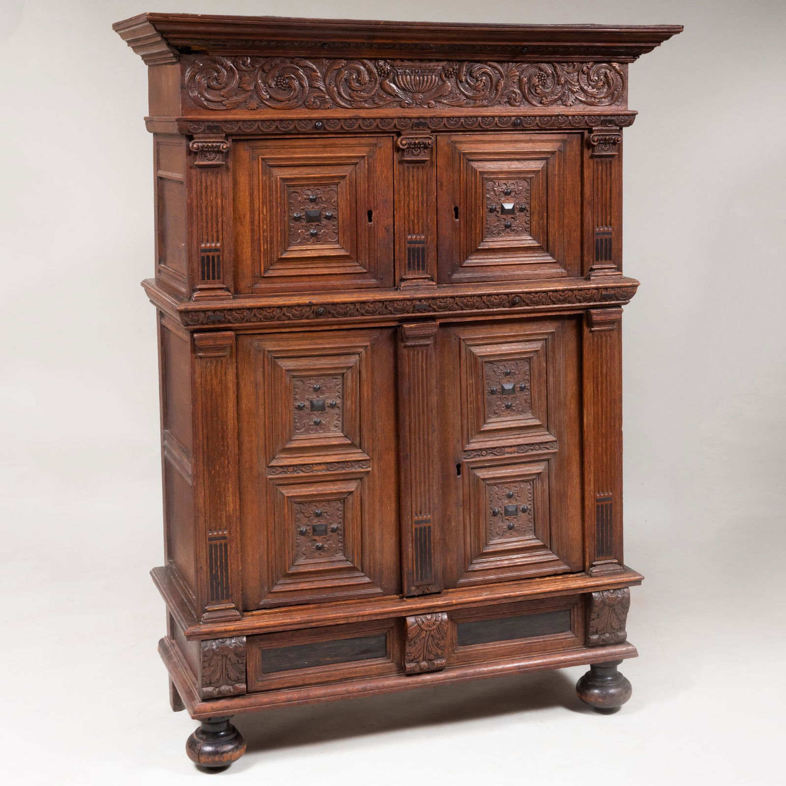 Dutch Renaissance Carved Oak and Ebony Kass: Dutch Renaissance Carved Oak and Ebony Kass The overhanging cornice above two short doors over a pair of cupboard doors opening to one shelf, above one long drawer, raised on bun feet in the front. 5
