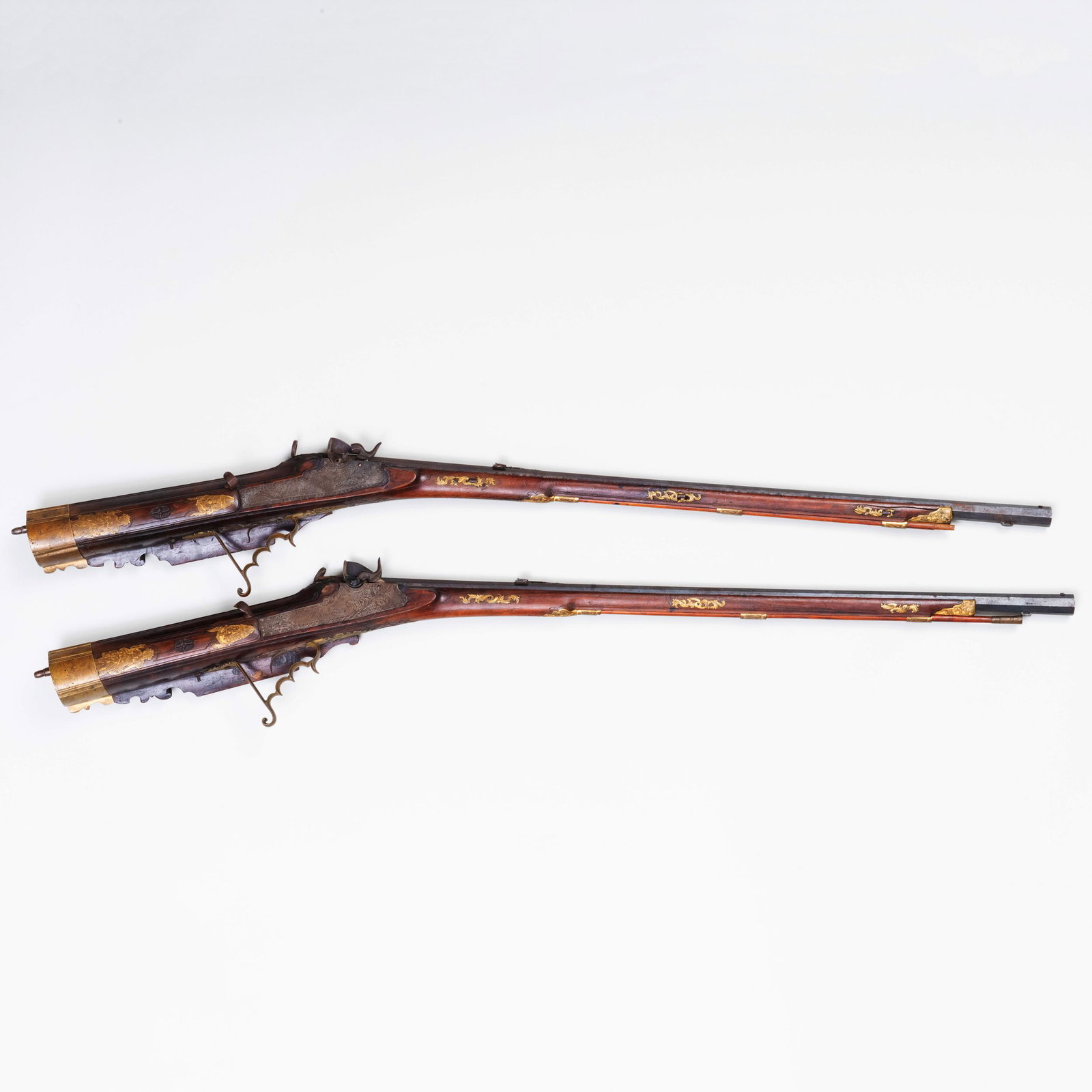Rare Pair of Austrian Percussion Back-Striking Target: Rare Pair of Austrian Percussion Back-Striking Target Rifles Converted from Flintlock by Vincenz Neumann a Leoben Fitted with a walnut stock, brass mounts an a silvered metal unidentified coat-of-arms