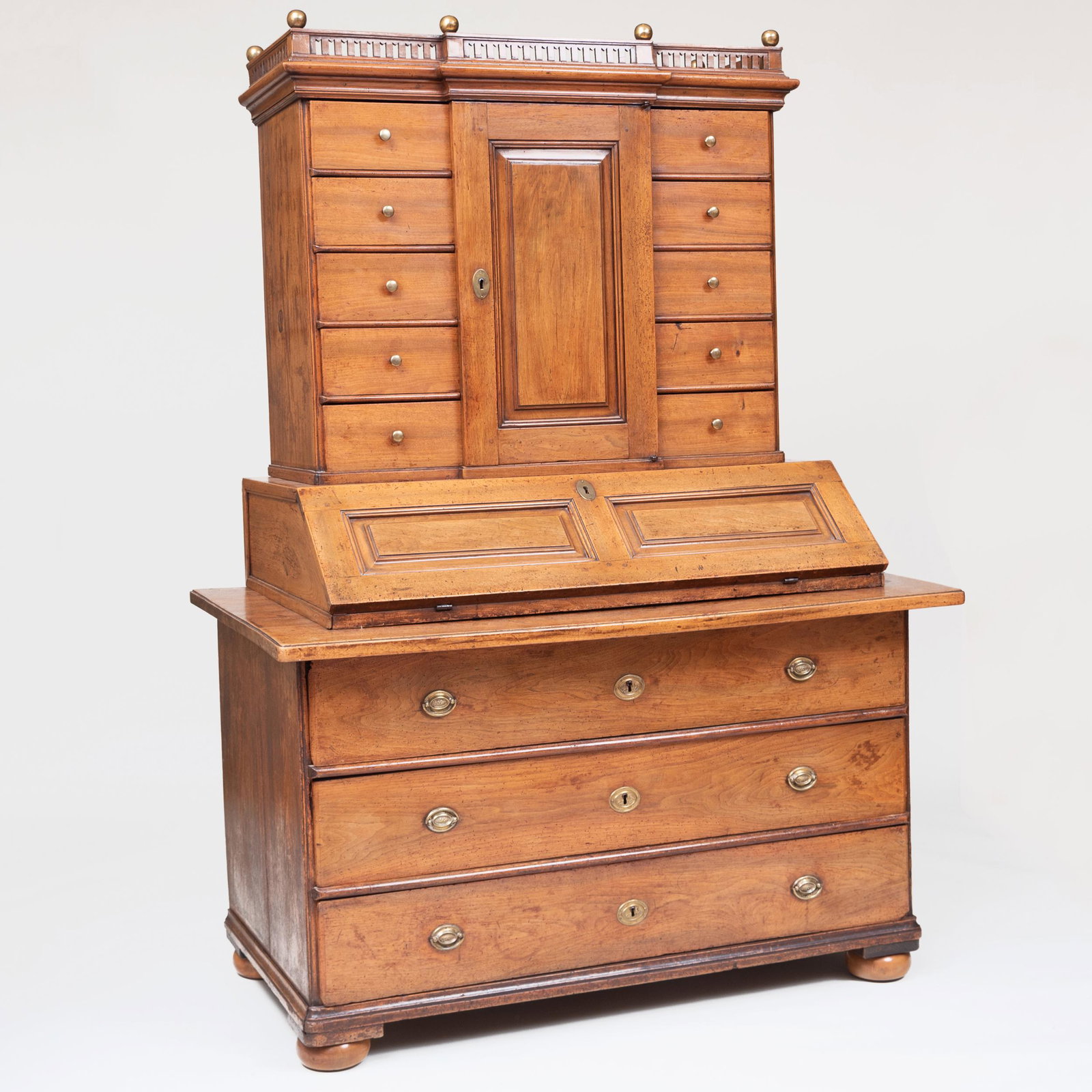 Dutch Late Baroque Provincial Walnut Slant-Front: Dutch Late Baroque Provincial Walnut Slant-Front Secretary In two parts; the upper section with a later pierced cornice above the central cupboard door opening to two short drawers above the slant-fro