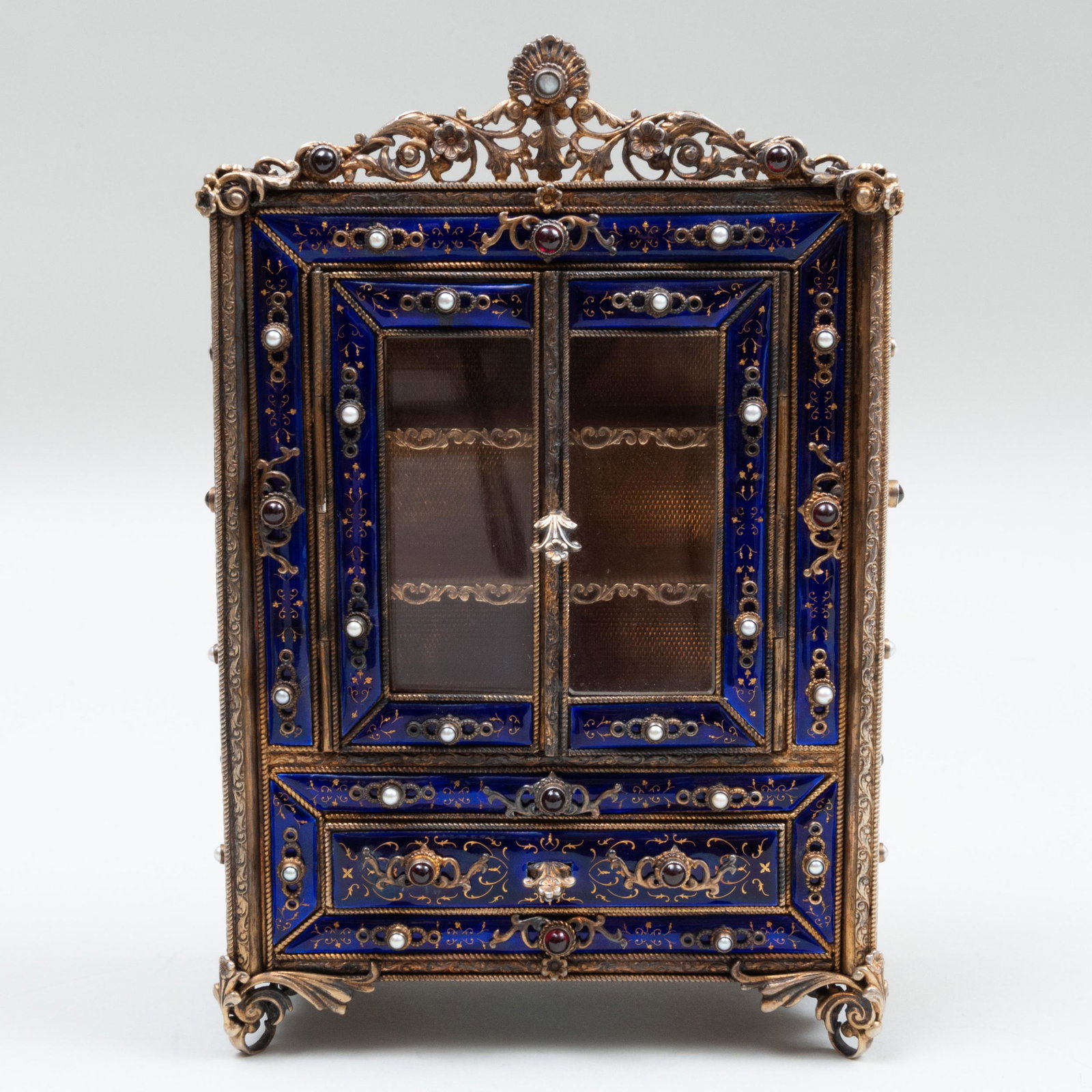 Miniature Silver-Gilt and Enamel Model of a Cabinet,: Miniature Silver-Gilt and Enamel Model of a Cabinet, Probably Austrian Apparently unmarked, inset with stones, doors and drawers are functional. 7 1/4 x 4 3/4 x 2 1/2 in., 33.4 oz. approx. gross weigh