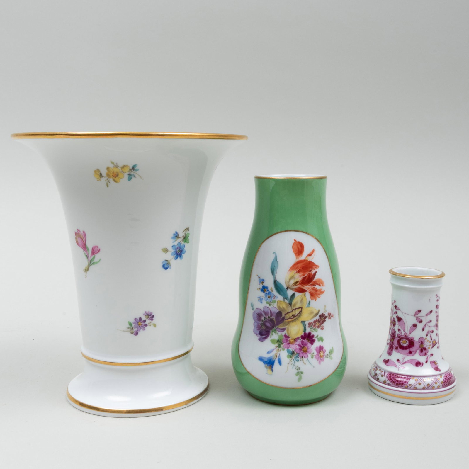 Group of Three Meissen Vases: Group of Three Meissen Vases Each with blue crossed swords and impressed numbers. Comprising: A flared conical vase A green ground lobed vase A puce decorated bud vase The conical vase 6 1/2 x 5 1/2 i