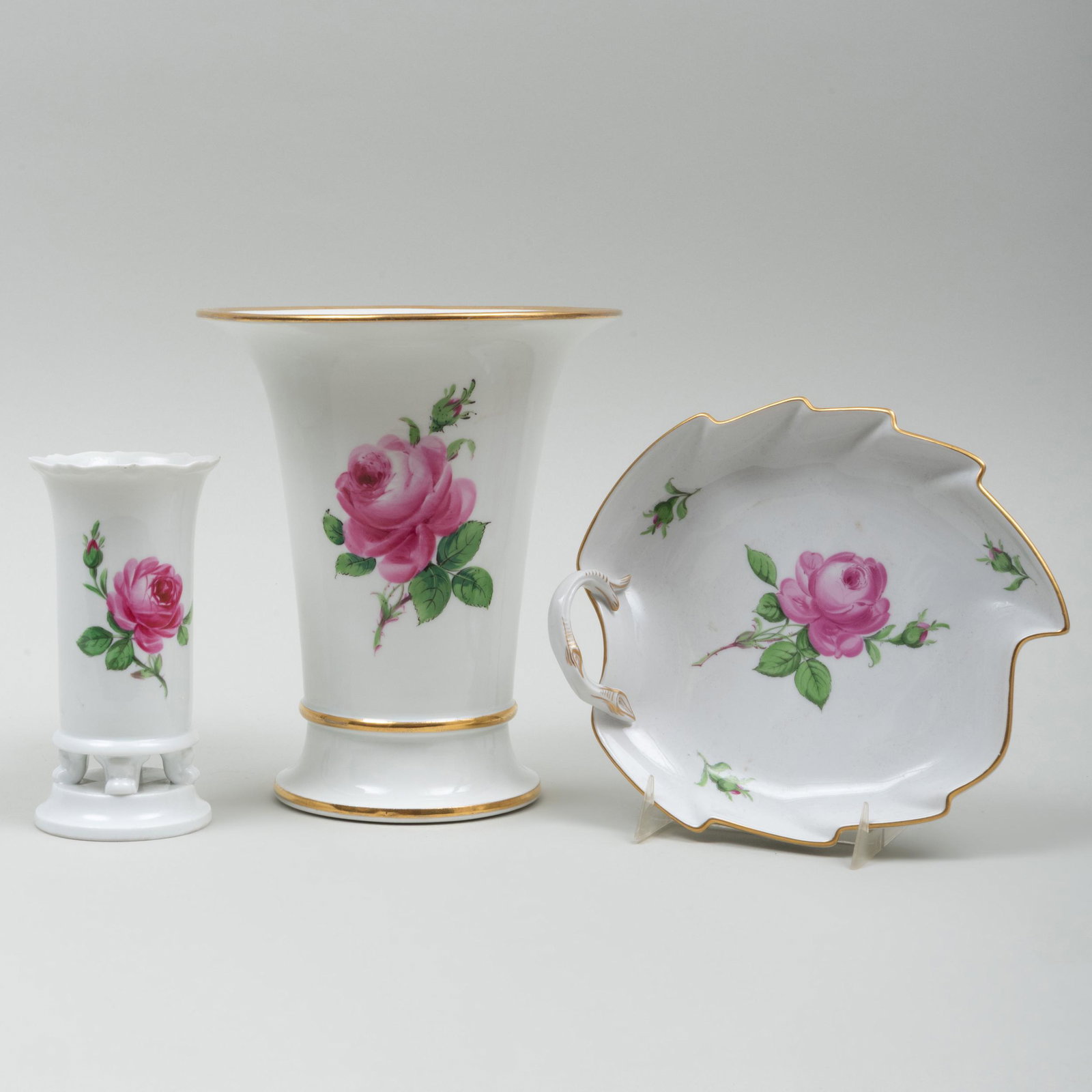 Group of Meissen Porcelain Rose Decorated Wares: Group of Meissen Porcelain Rose Decorated Wares Each with blue crossed sword and impressed numbers. Comprising: A flaring conical vase A bud vase A leaf shaped dish The flaring vase 7 3/4 x 6 5/8 in. 