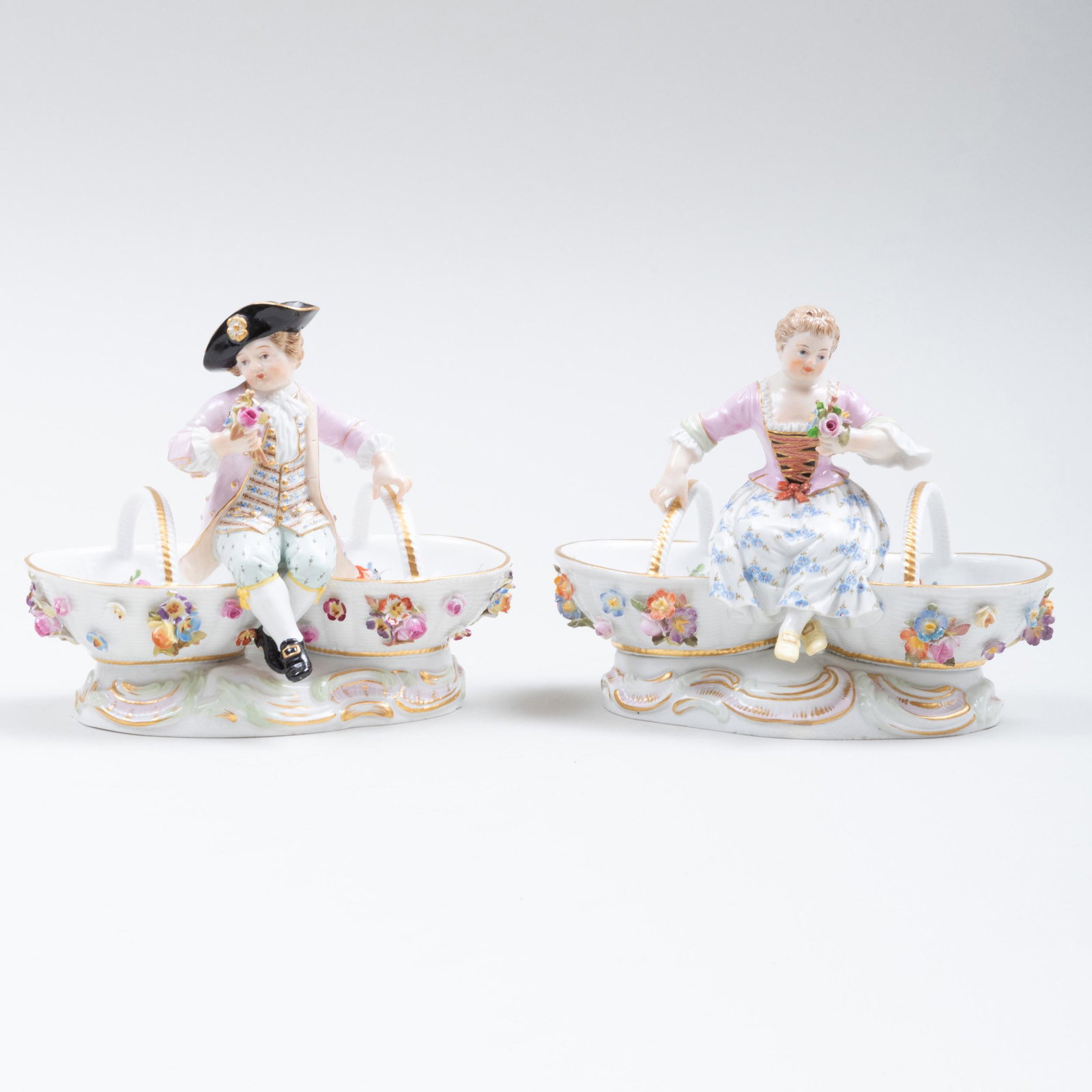 Pair of Meissen Porcelain Figural Salt Cellars: Pair of Meissen Porcelain Figural Salt Cellars Each with incised blue crossed swords, incised and impressed numbers. 4 5/8 x 5 3/4 x 3 1/4 in.