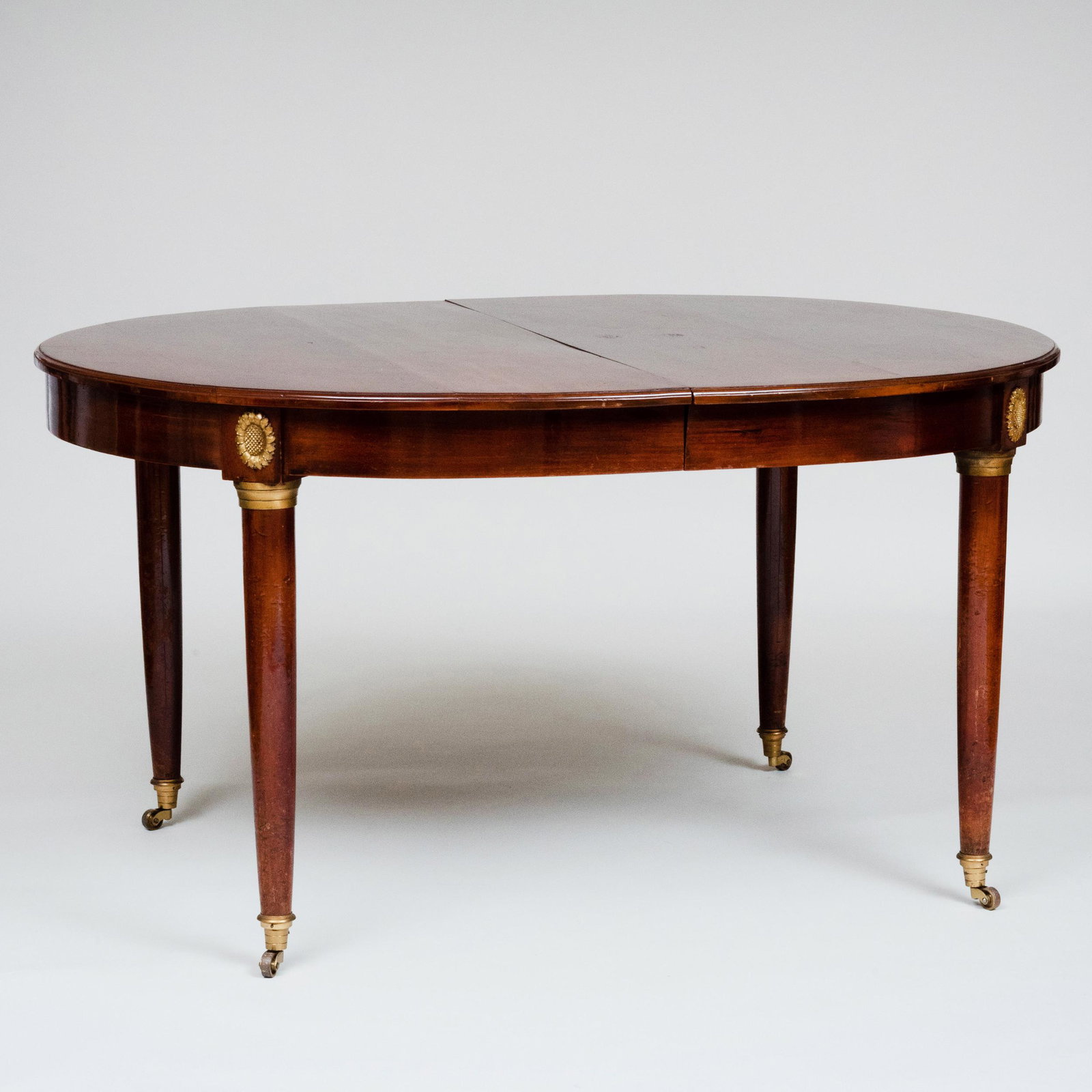 Louis XVI Style Ormolu-Mounted Mahogany Extension: Louis XVI Style Ormolu-Mounted Mahogany Extension Dining Table Fitted with one 30 inch leaf, raised on casters. 30 1/2 x 4 ft. 9 in. x 47 1/2 in. (closed), 30 1/2 x 7 ft. 3 in. x 47 1/2 in. (open). Th