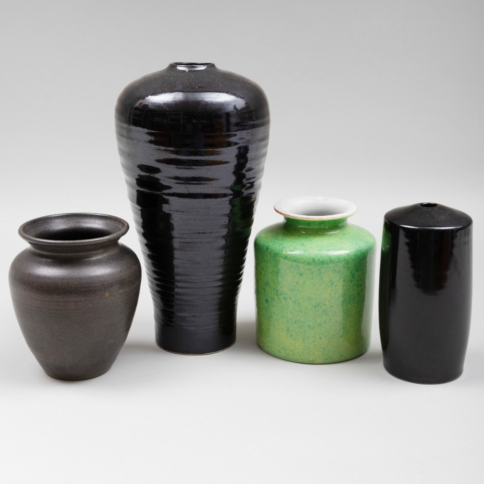 Group of Four Contemporary Porcelain and Earthenware: Group of Four Contemporary Porcelain and Earthenware Vases Variously incised. The porcelain comprising: A green glazed example A small black glazed example The earthenware comprising: A tall black gla