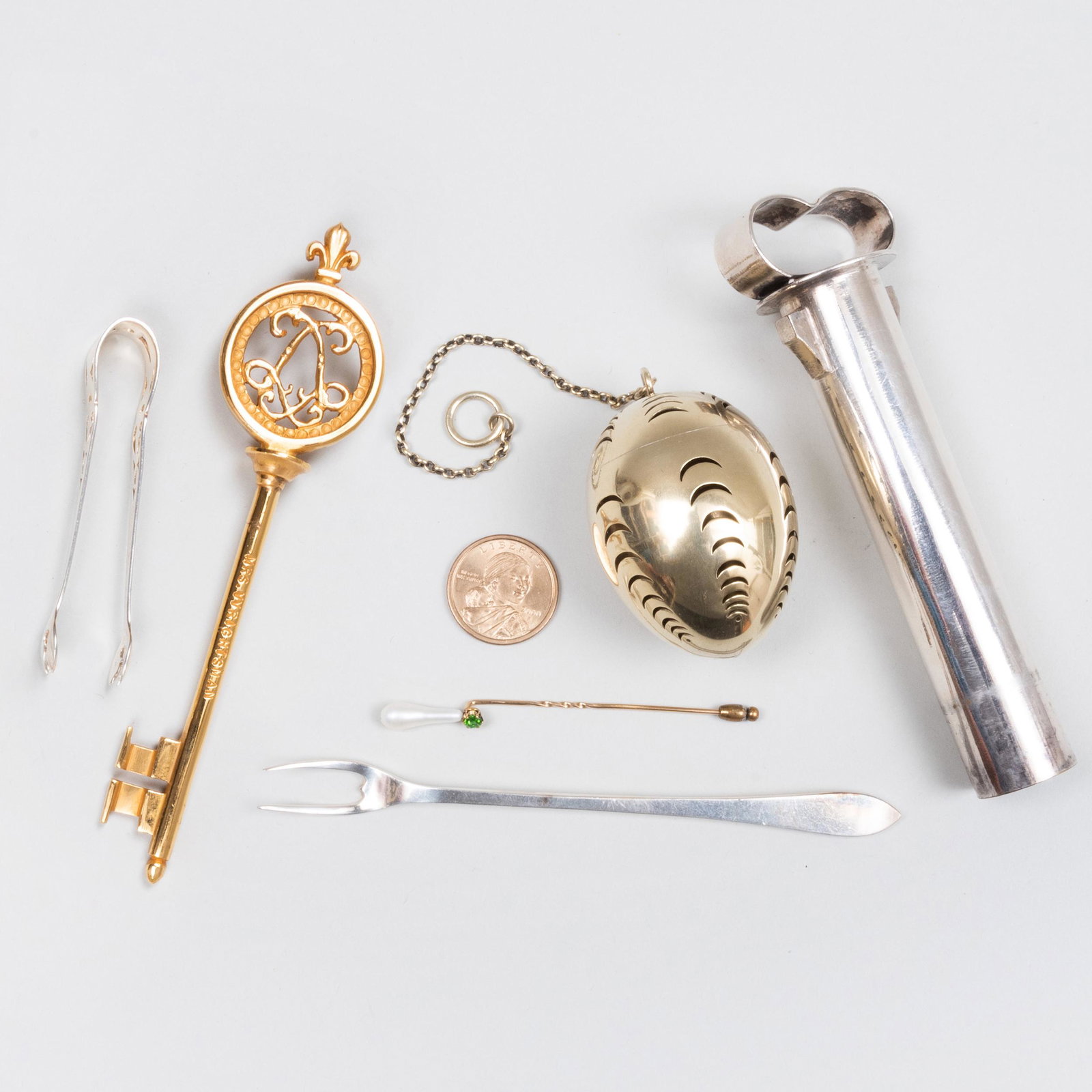 Group of Silver Articles: Group of Silver Articles Variously marked. Comprising: A pair of Webster sugar nips, marked 'Sterling' A Tiffany & Co. shellfish fork, marked 'Sterling' A Tiffany & Co. pomander, marked 'Sterling', en