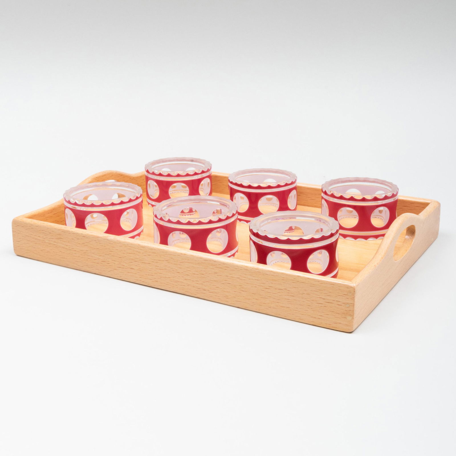 Set of Six Saint Louis Claret and White Overlay Glass: Set of Six Saint Louis Claret and White Overlay Glass Napkin Rings Together with a small wood tray. The napkin rings 2 1/8 in. diam. With card from James Robinson, NY. The Private Collection of Jayne