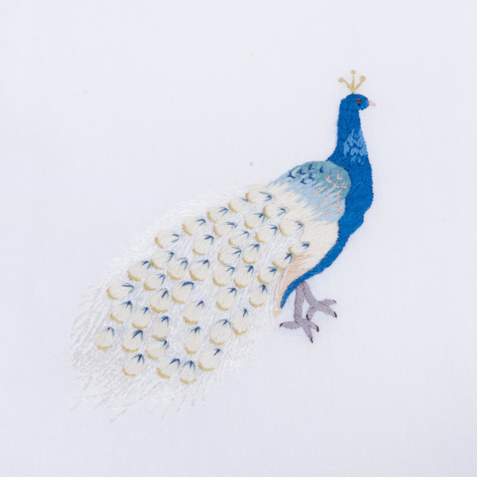 Group of Embroidered Linens: Group of Embroidered Linens Comprising: Seven guest towels, four decorated with peacocks, 24 x 15 in. Set of eight napkins embroidered with feathers, 12 x 12 in. The Private Collection of Jayne Wright