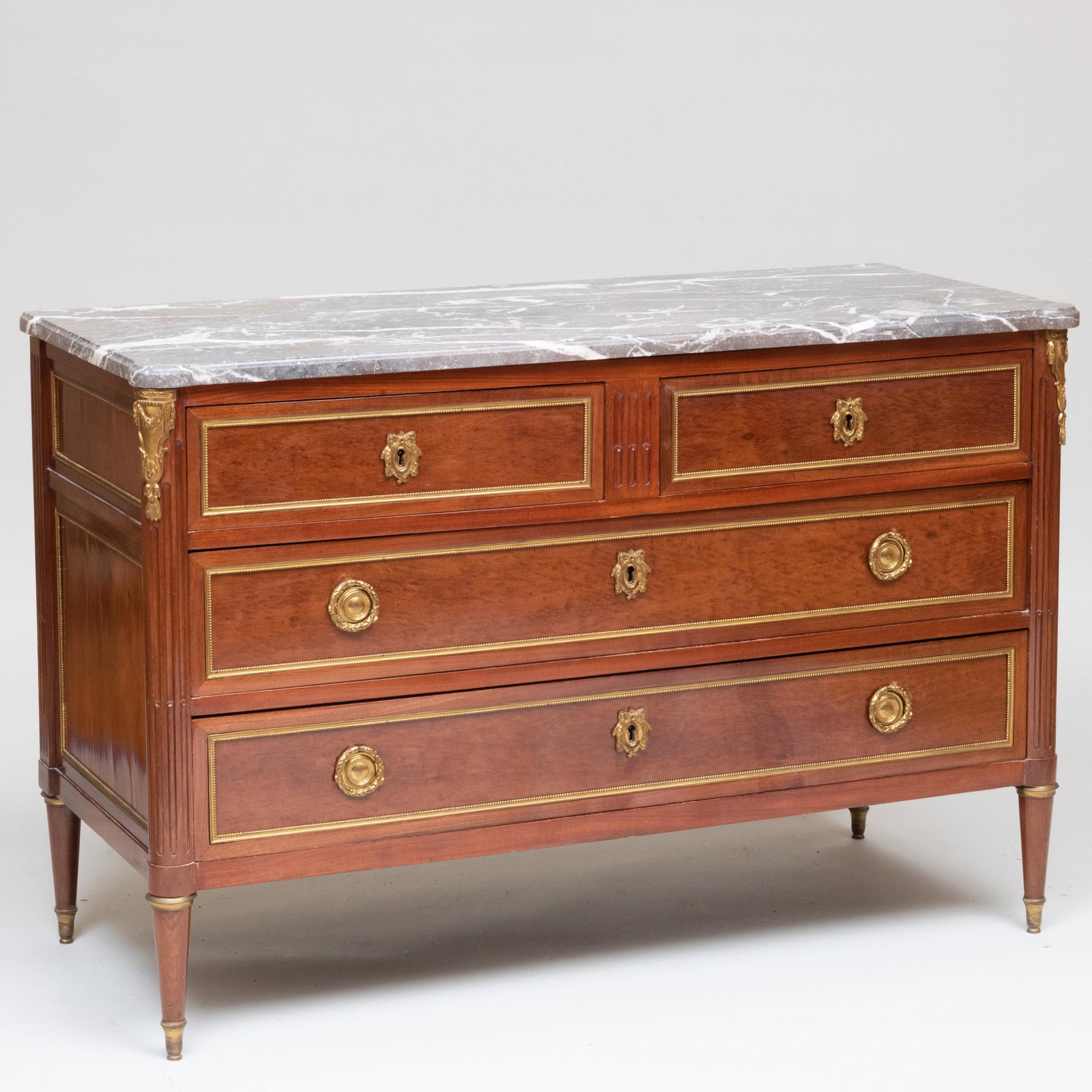 Late Louis XVI Brass-Mounted Mahogany Commode, Stamped: Late Louis XVI Brass-Mounted Mahogany Commode, Stamped E. Avril, JME Étienne Avril maître in 1774. Fitted with a marble top with eared corners above two short and two long drawers. 33 3/4 x 4 ft.