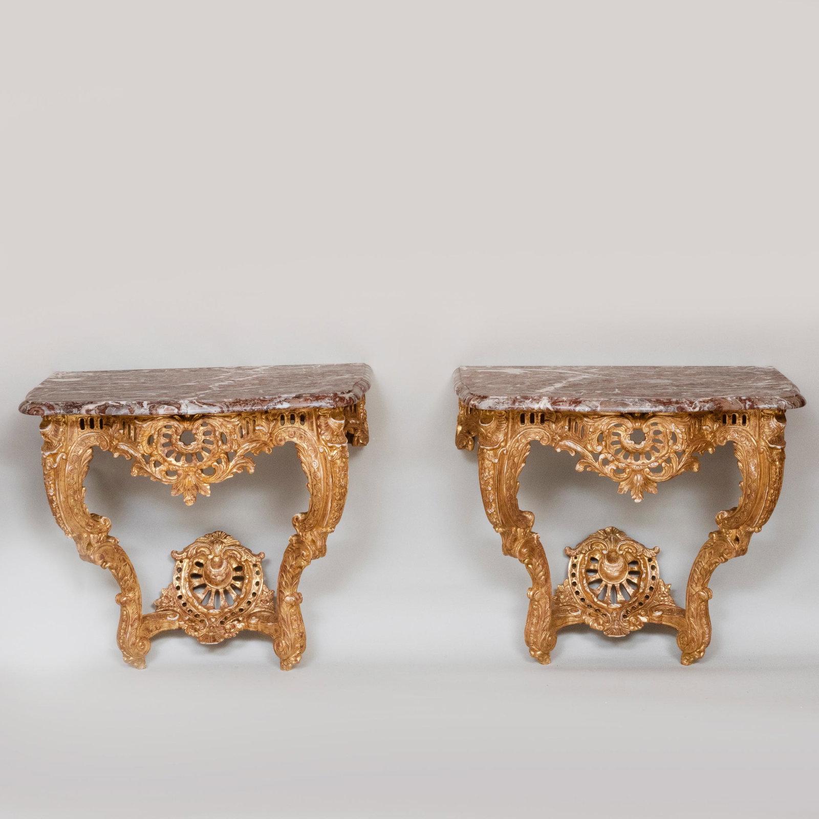Pair of Louis XV Style Giltwood Consoles: Pair of Louis XV Style Giltwood Consoles Each fitted with a molded serpentine front marble top with eared corners. 32 1/4 x 36 x 21 3/4 in. Gracious Living: The Collection From a Home Designed by Kevi