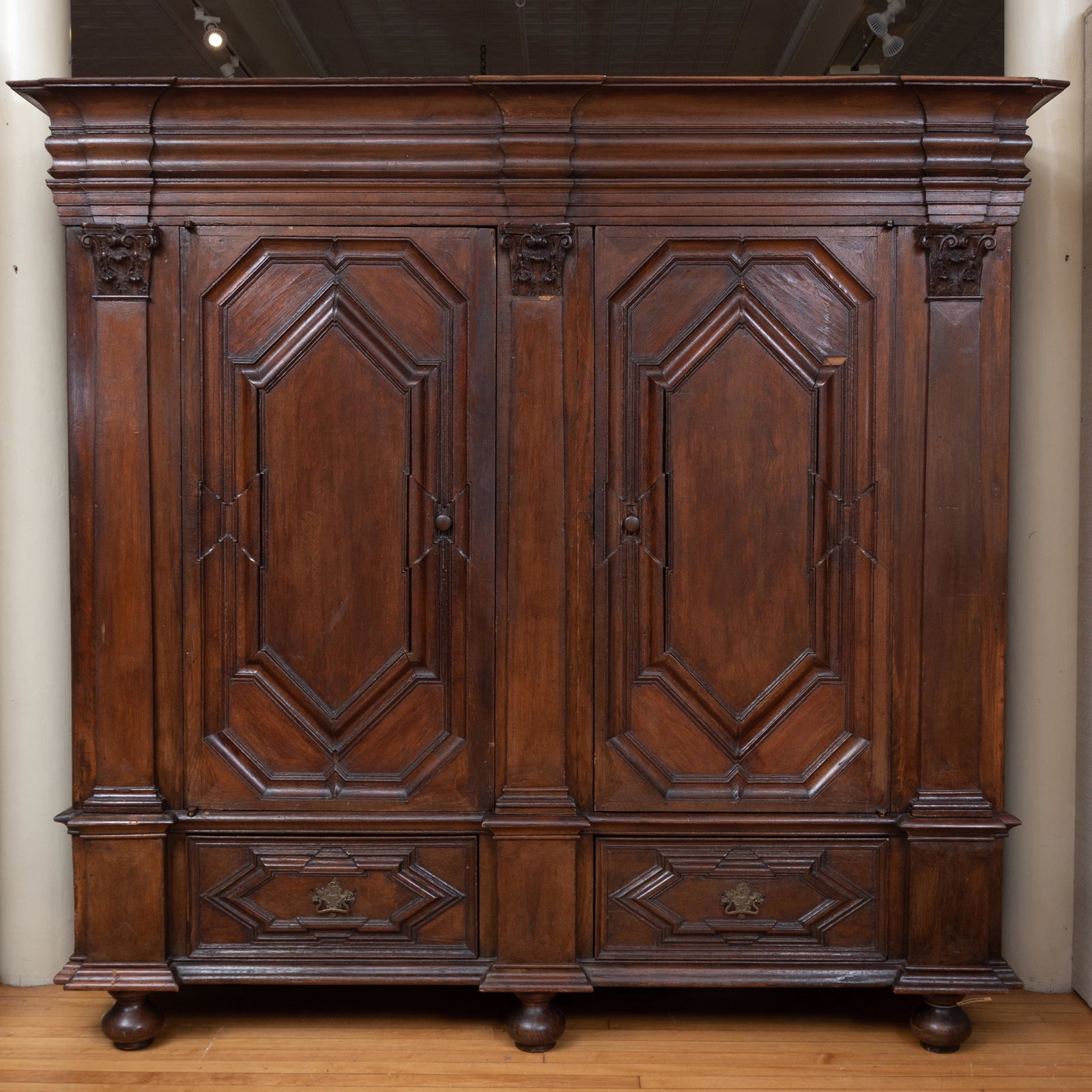 Large French Carved Oak Armoire, Possibly Belgian: Large French Carved Oak Armoire, Possibly Belgian The overhanging cornice above a pair of paneled doors opening to shelves, over a pair of drawers, raised on later bun feet. 7 ft. 3 1/2 x 7 ft. 5 in. 