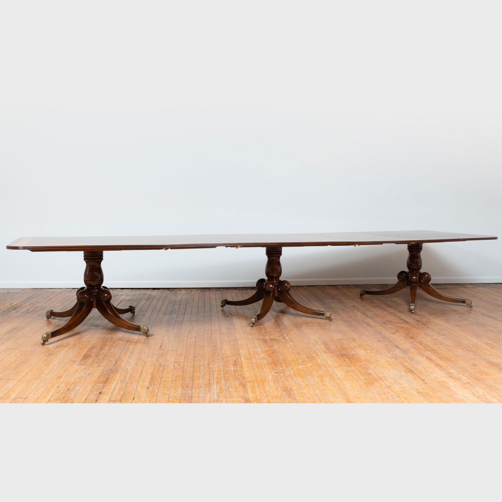 George III Style Inlaid Mahogany Triple-Pedestal Dining: George III Style Inlaid Mahogany Triple-Pedestal Dining Table, of Recent Manufacture 29 1/2 x 10 ft. 11 in. x 48 in. (closed), 29 1/2 x 12 ft. 11 in. x 48 in. (fully extended with two additional leave