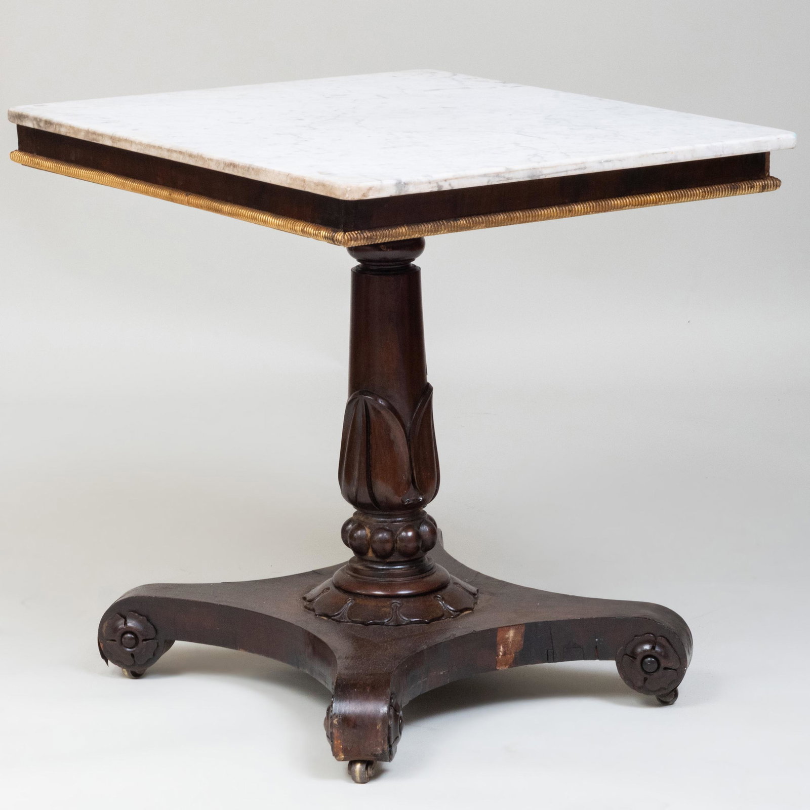 Victorian Carved Mahogany and Parcel-Gilt Center Table: Victorian Carved Mahogany and Parcel-Gilt Center Table Fitted with a marble top. 29 x 30 x 26 1/2 in. Master Class: John Rosselli's Artful Eye