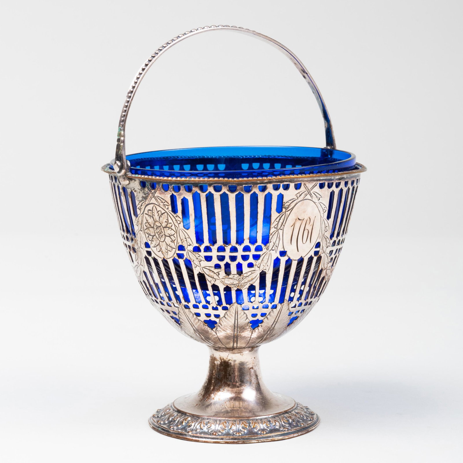 Sheffield Plate Basket with Swing Handle and Blue Glass: Sheffield Plate Basket with Swing Handle and Blue Glass Liner Monogram to base, inscribed '1761'. 4 1/4 x 4 1/4 in. diam. Property from the late Zane Studenroth