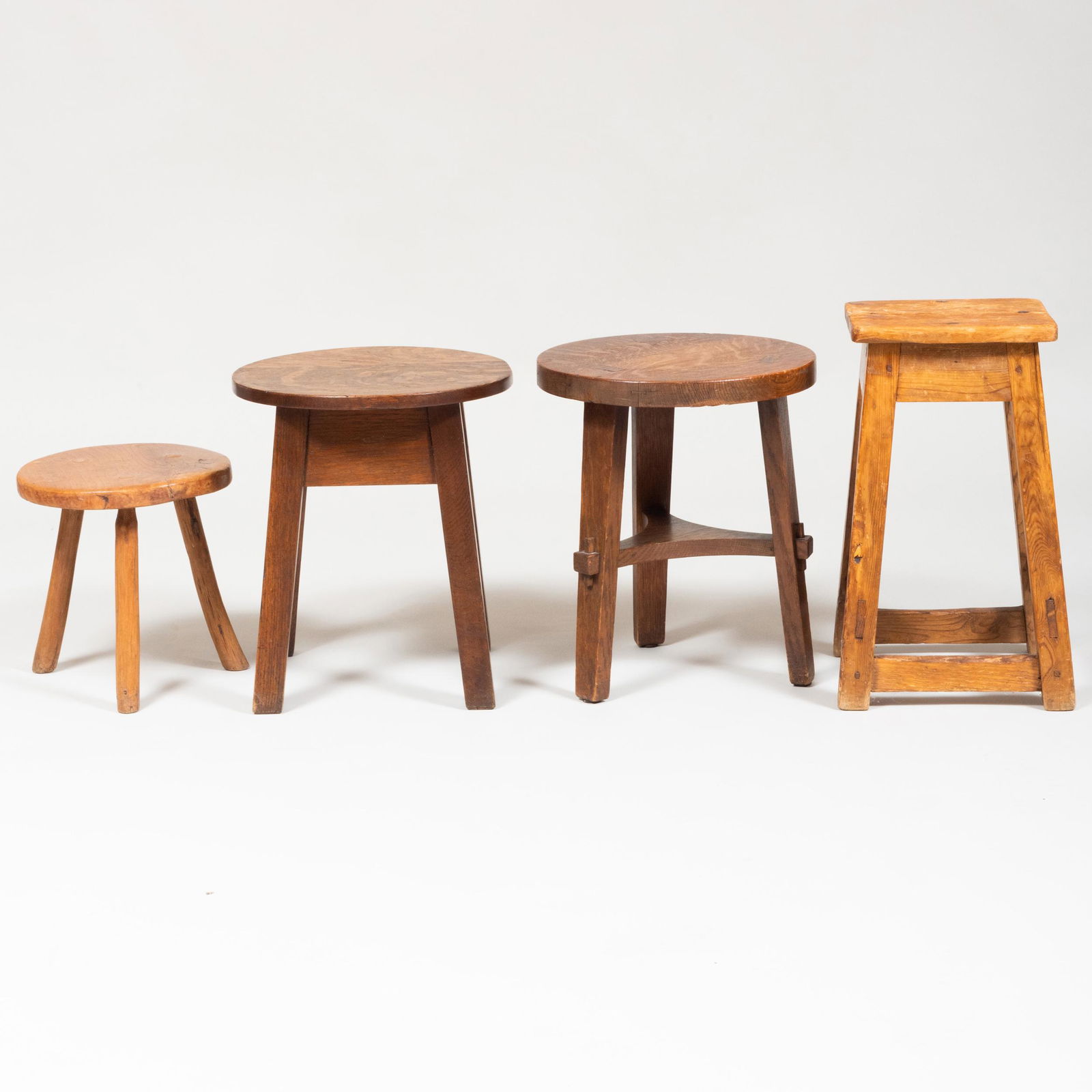 Collection of Four Stools: Collection of Four Stools Comprising: Two Arts and Crafts oak stools, one with a Stickley Bros. Label. A pine stool A rustic tripod stool The tallest 20 1/4 x 12 1/4 x 12 1/4 in.