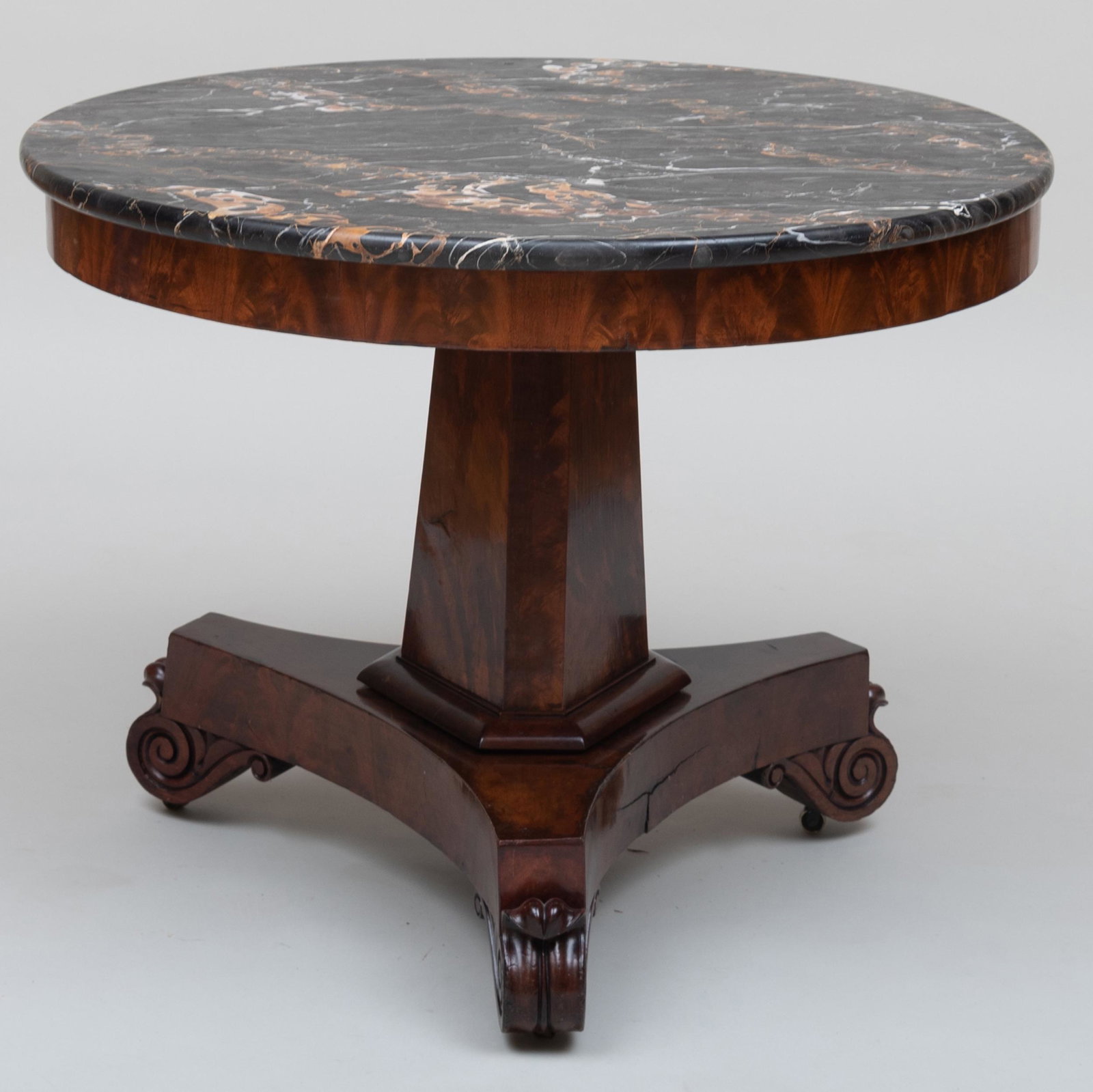 Late Federal Carved Mahogany Center Table, Boston: Late Federal Carved Mahogany Center Table, Boston Fitted with a black porto marble top, raised on casters. 28 x 36 1/4 in. diam.