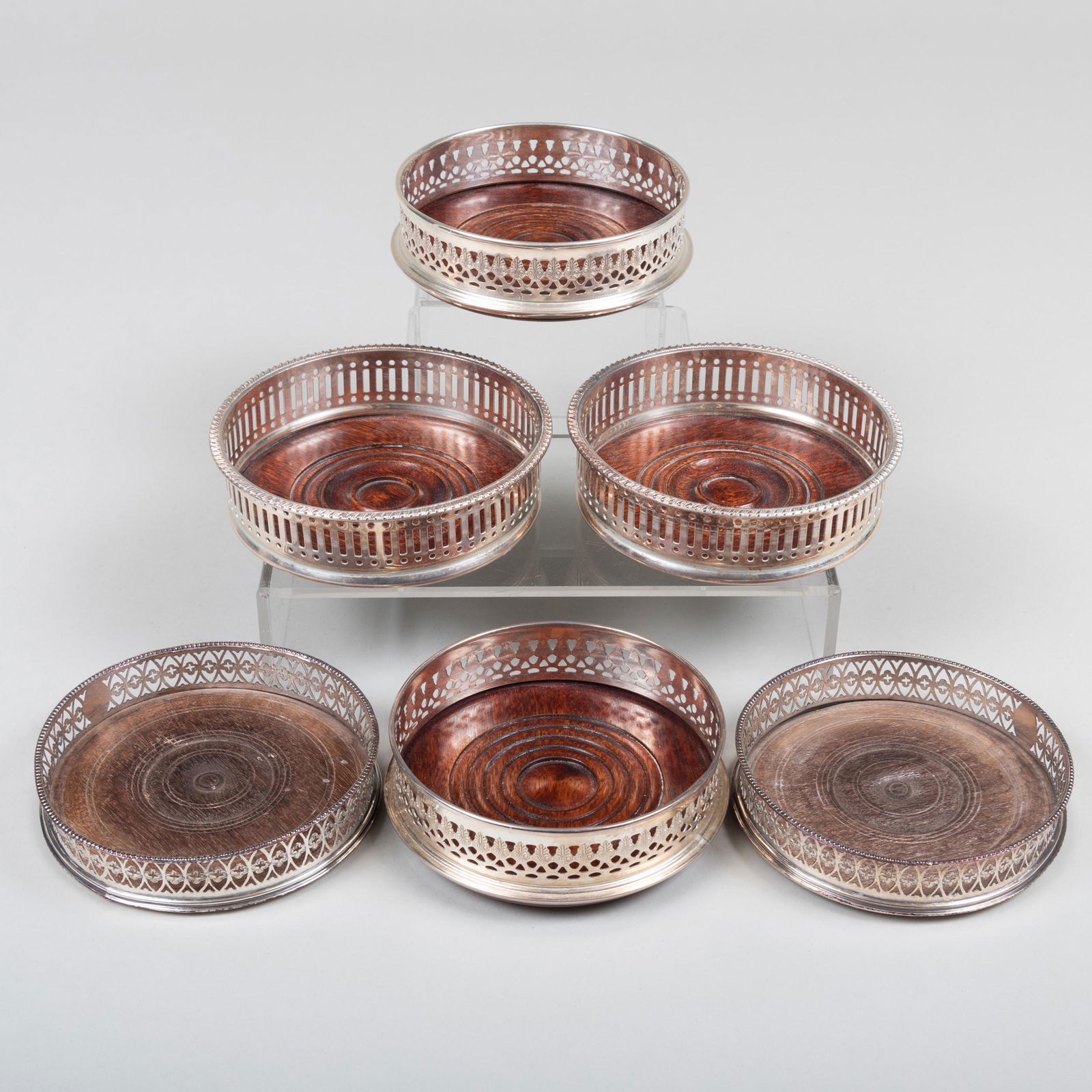 Three Pairs of Silver Plated Bottle Coasters: Three Pairs of Silver Plated Bottle Coasters Together with a small oak circular tray. The coasters 5 1/4 in. diam., the tray 9 in. diam. Property from the Estate of Carol O. Selle