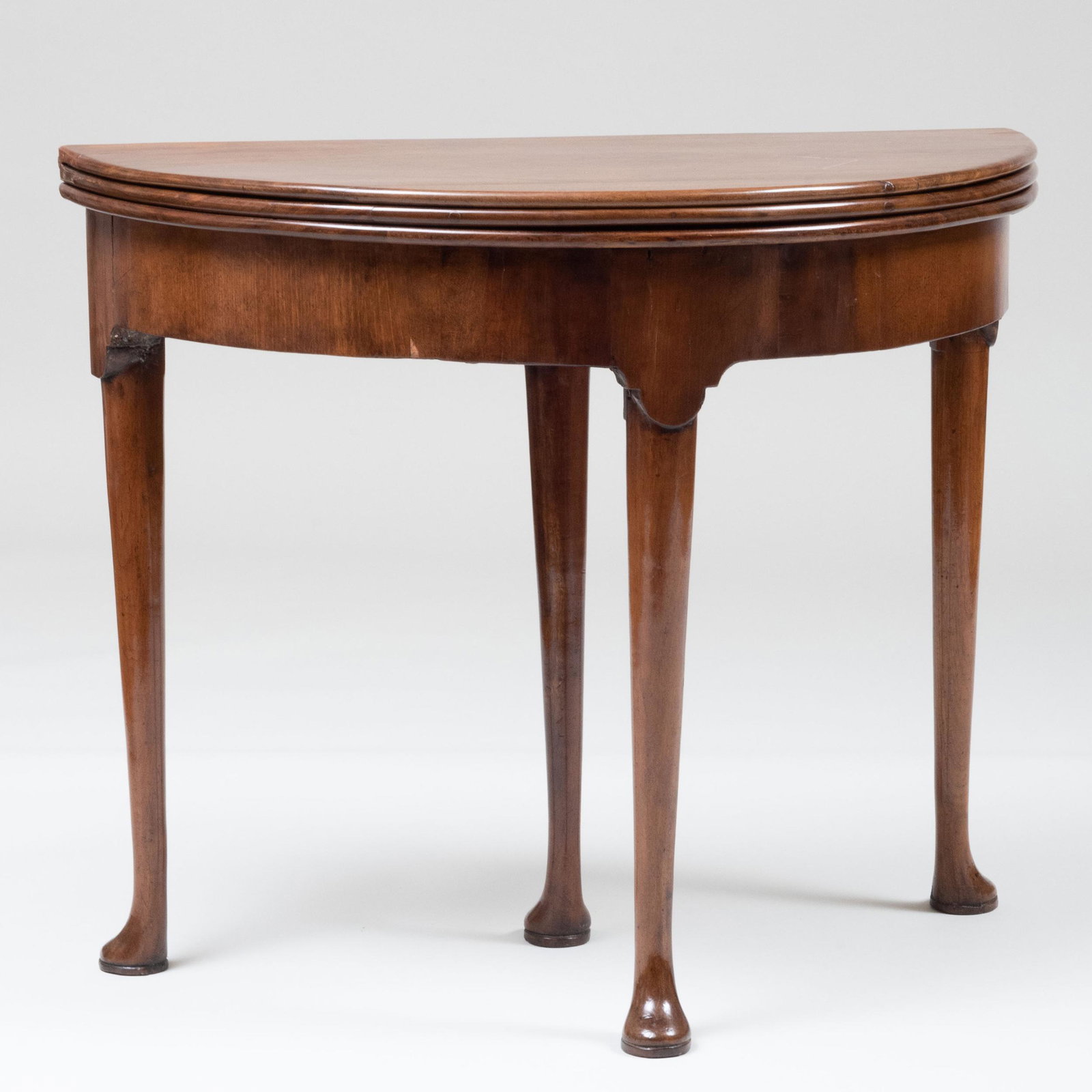 George II Walnut Triple-Top Tea/Games Table: George II Walnut Triple-Top Tea/Games Table The back leg opening to a welled interior, the gaming surface is velvet lined with wells. 28 3/4 x 34 1/4 x 16 3/4 in. (closed); 28 x 34 1/4 x 34 in. (open)