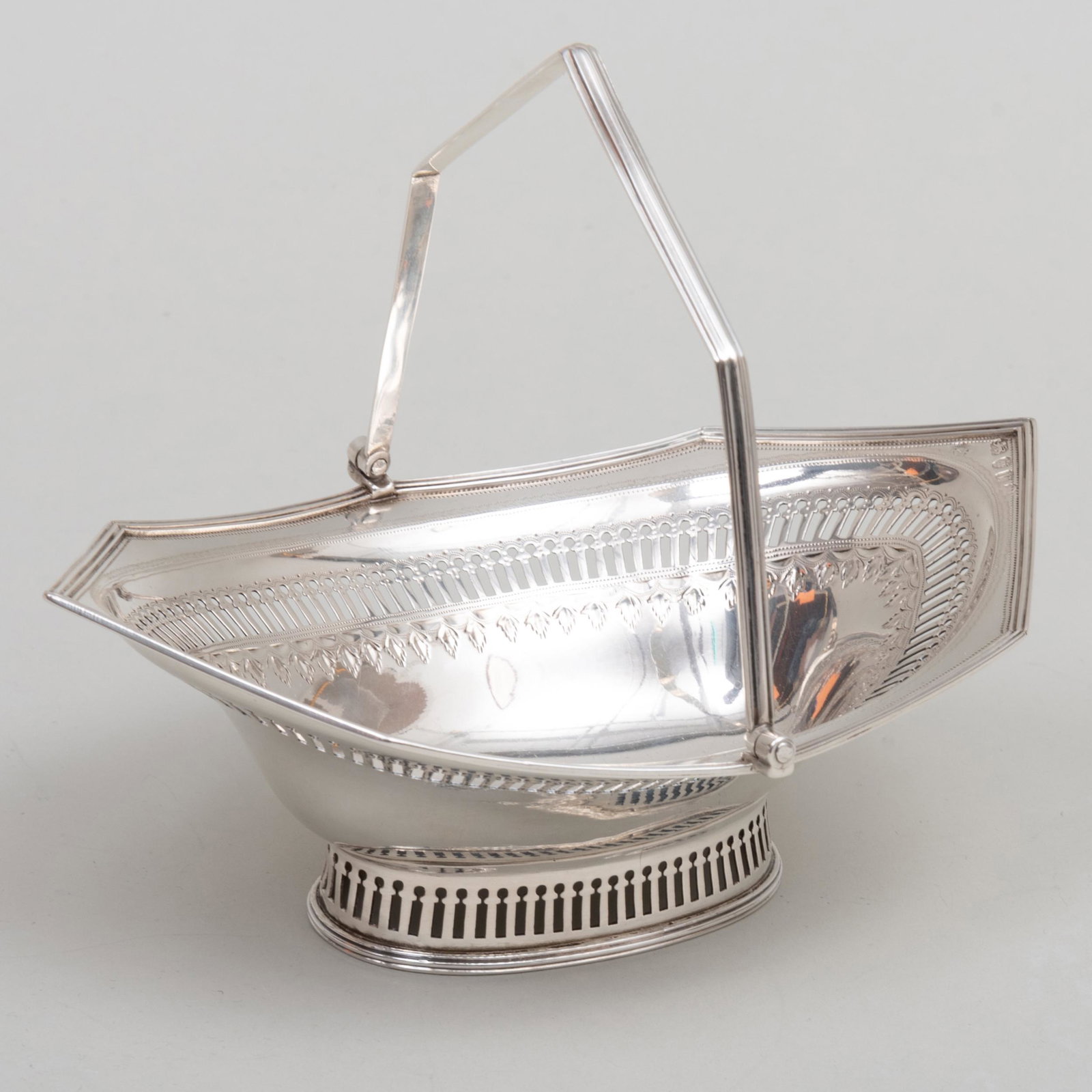 George III Silver Sweetmeat Basket with Swing Bale: George III Silver Sweetmeat Basket with Swing Bale Handle Mark of Robert Hennell, London, 1792; engraved with crest. 6 x 7 x 5 1/4 in., 5.1 oz. approx. gross weight. Asprey, New York, April, 19, 1994.