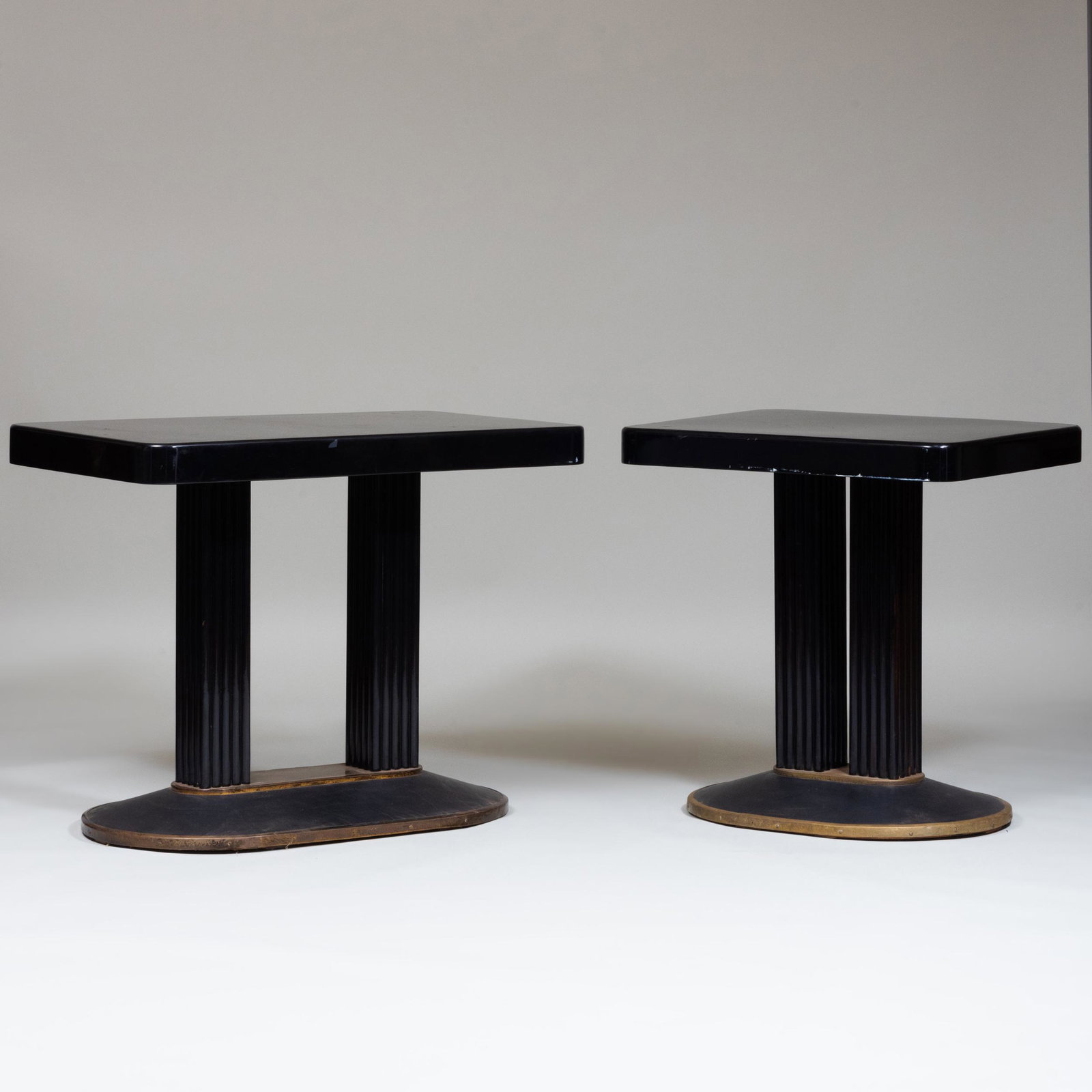Two Similar American Art Deco Ebonized and Brass: Two Similar American Art Deco Ebonized and Brass Console Tables The larger 31 x 39 1/2 x 23 1/2 in. Property from the Estate of Virginia M. Zabriskie