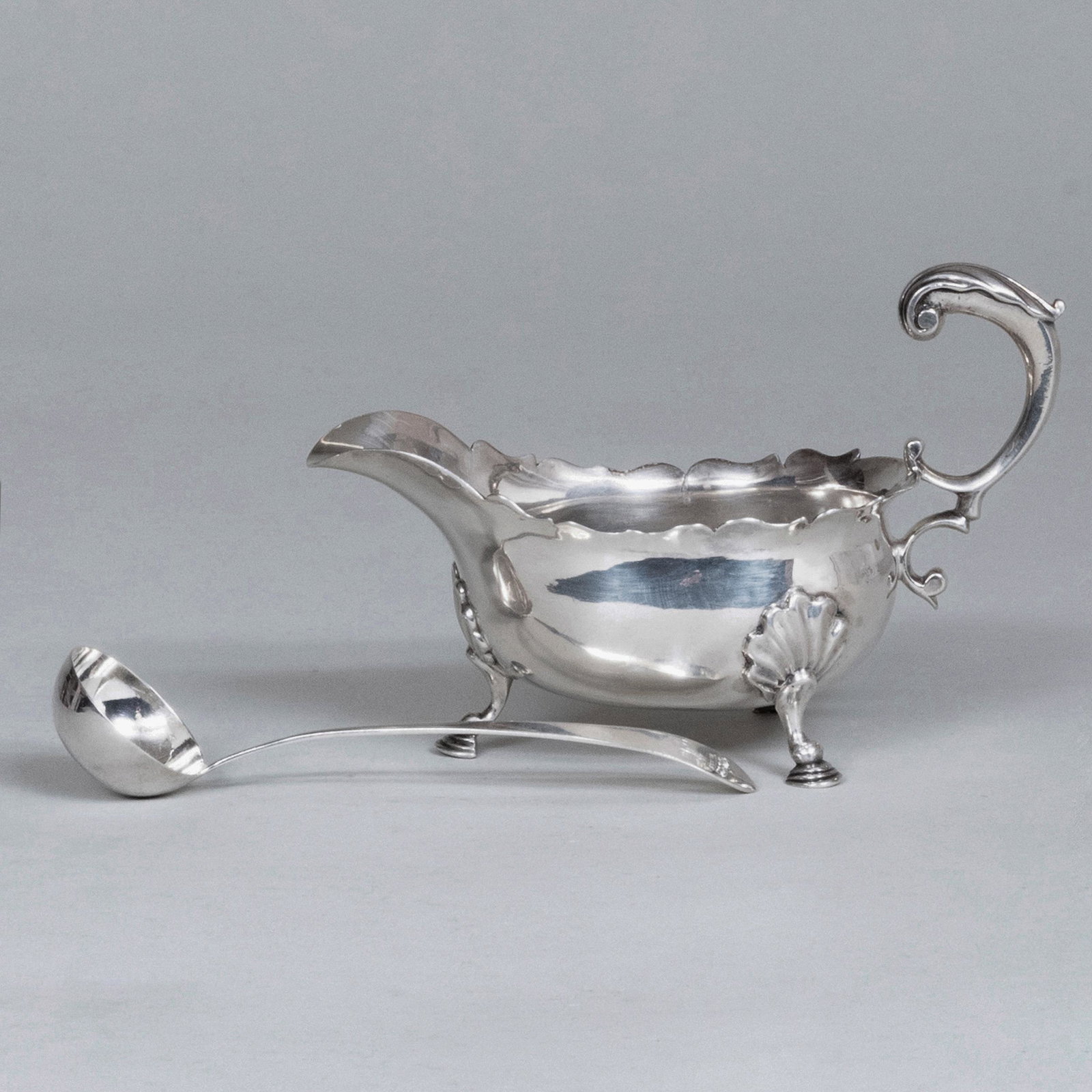 George II Silver Sauce Boat and a Ladle: George II Silver Sauce Boat and a Ladle Each with crowed 'A' monogram; the sauce boat marked London, 1756, maker's mark 'RC'; the ladle marked for Chester, maker's mark 'AC', date mark lacking. The sa