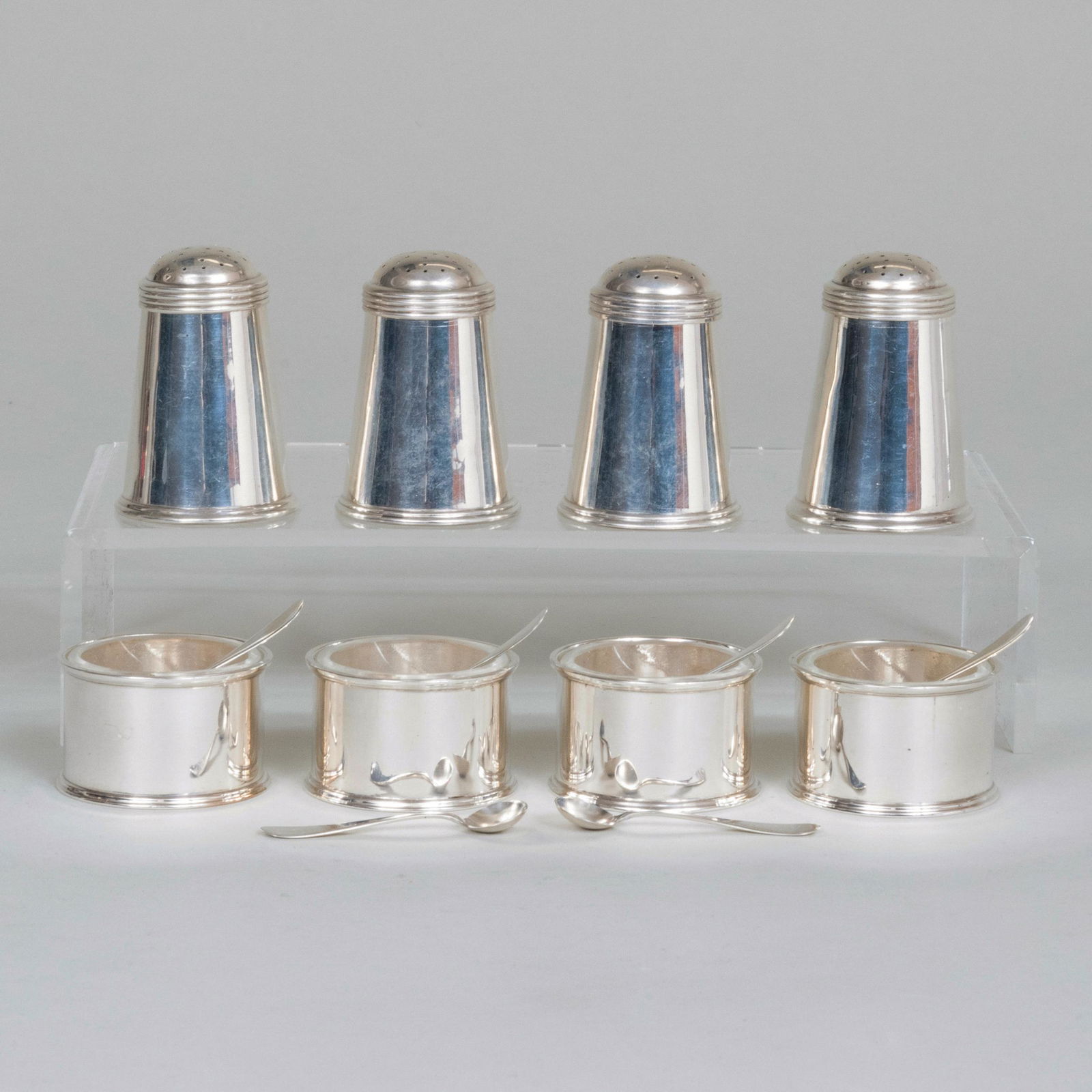 English Silver Condiment Set: English Silver Condiment Set Each with mark of James Robinson, London, 1960 & 1962. Comprising: A set of four casters A set of four salt cellars with glass liners Together with: A set of six American
