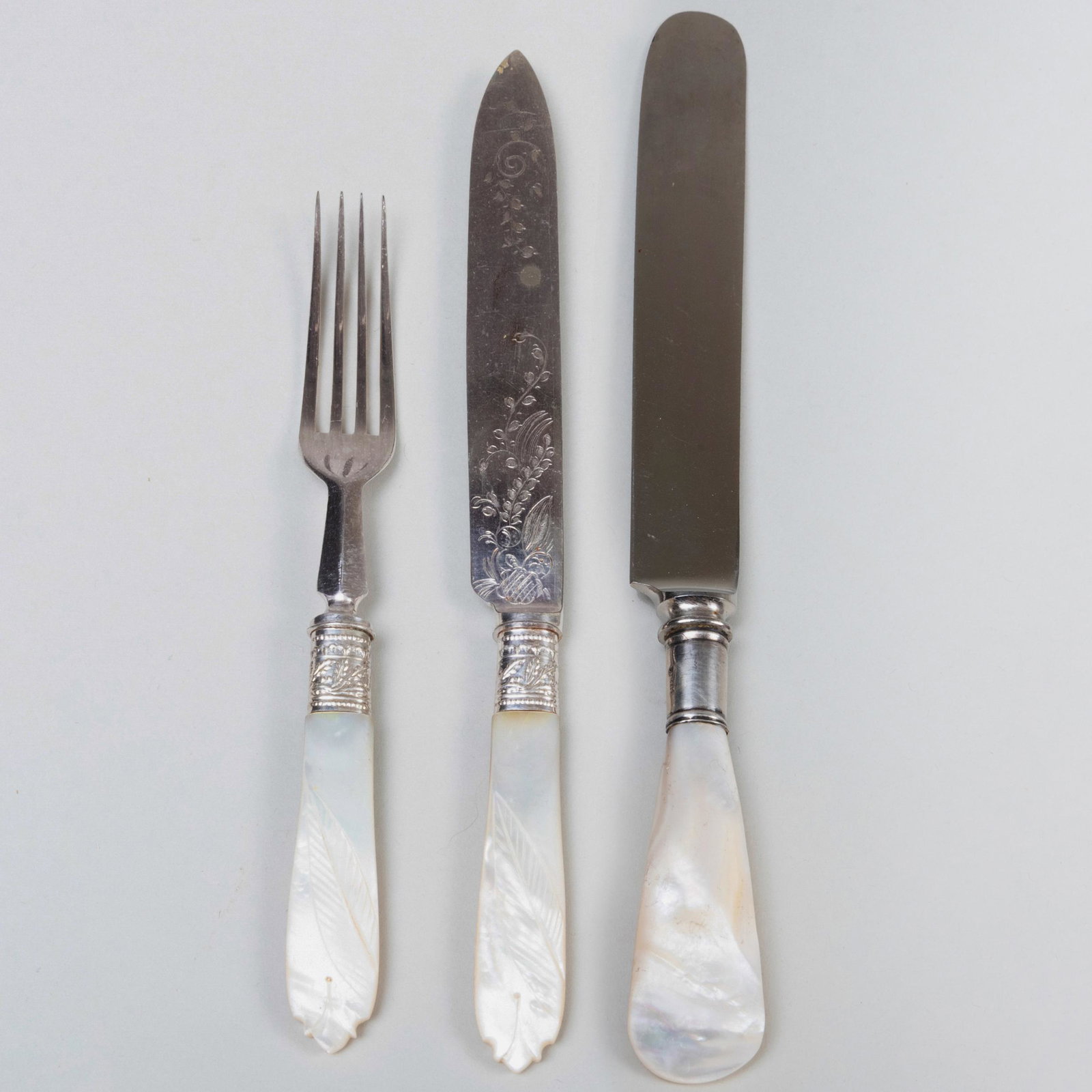 Silver Plate and Mother-of-Pearl Fruit Service for: Silver Plate and Mother-of-Pearl Fruit Service for Twelve Together with a set of six American silver mounted mother-of-pearl knives, marked 'Sterling'. The largest 8 in. long. The Collection of Dr. Da