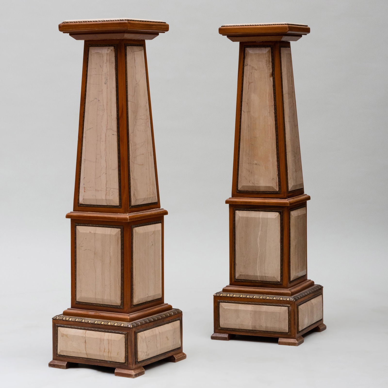 Pair of Modern Gilt-Metal-Mounted Walnut and: Pair of Modern Gilt-Metal-Mounted Walnut and Filled-Travertine Pedestals 45 1/2 x 13 1/8 x 13 1/8 in. The Neoclassicist: Niall Smith