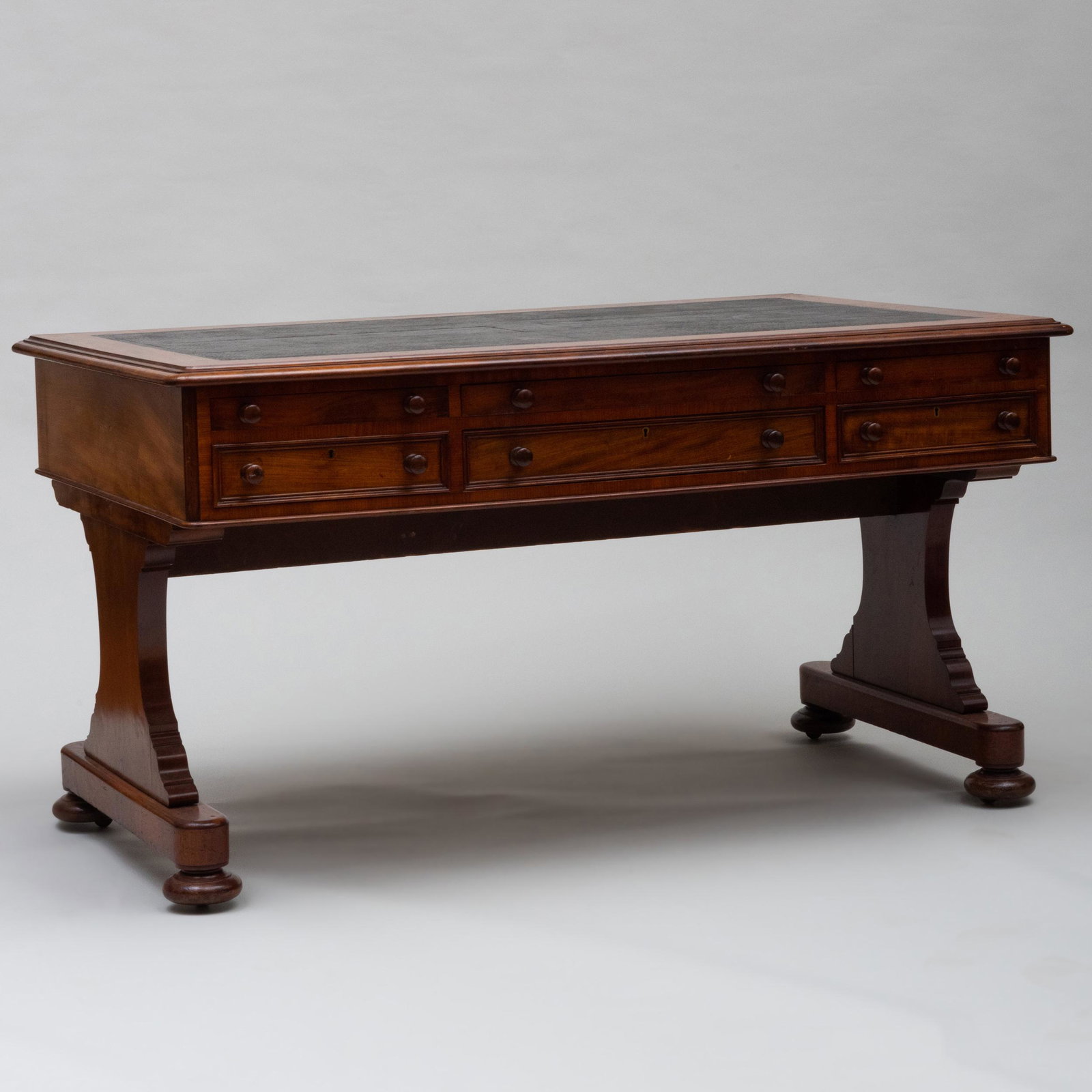 Unusual Victorian Mahogany and Leather Partner's Desk: Unusual Victorian Mahogany and Leather Partner's Desk Fitted with an inset leather writing surface, above three writing slides over three drawers on both sides, raised on trestle supports on bun feet 