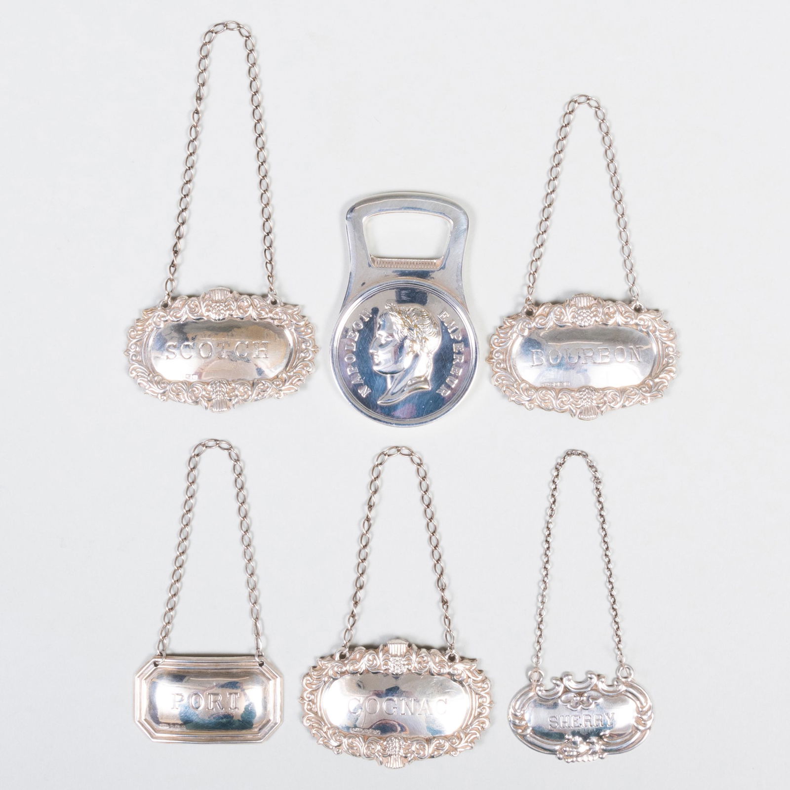 Group of Five Silver Bottle Ticket Labels and a (1 of 2)