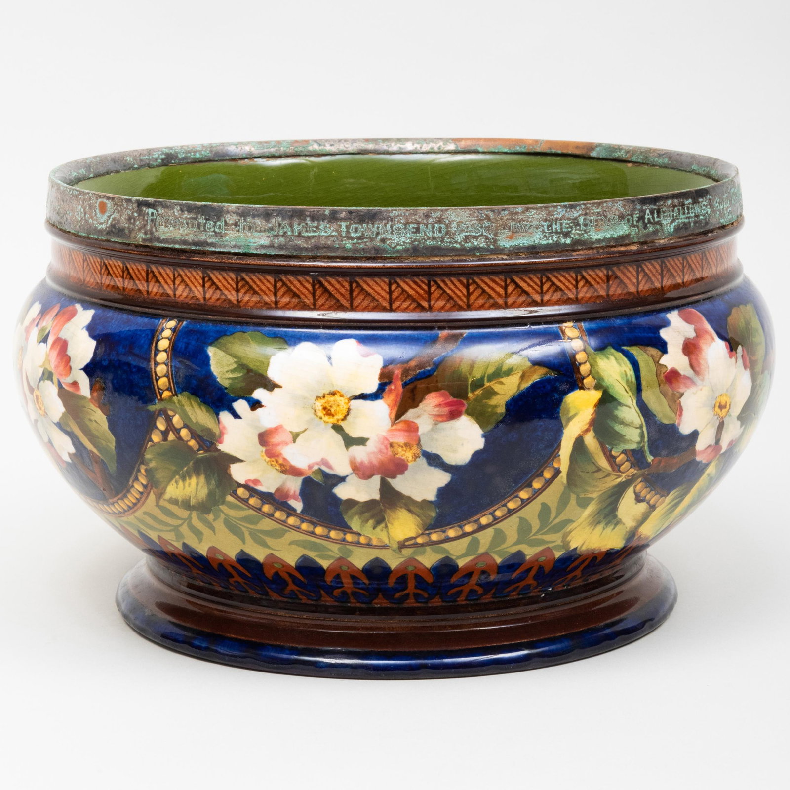 Royal Doulton Metal-Mounted Glazed Earthenware: Royal Doulton Metal-Mounted Glazed Earthenware Jardiniere with Flower Decoration Various impressed and printed marks; the mount inscribed 'Presented to James Townsend Esq. by the Boys of Allhollows, A