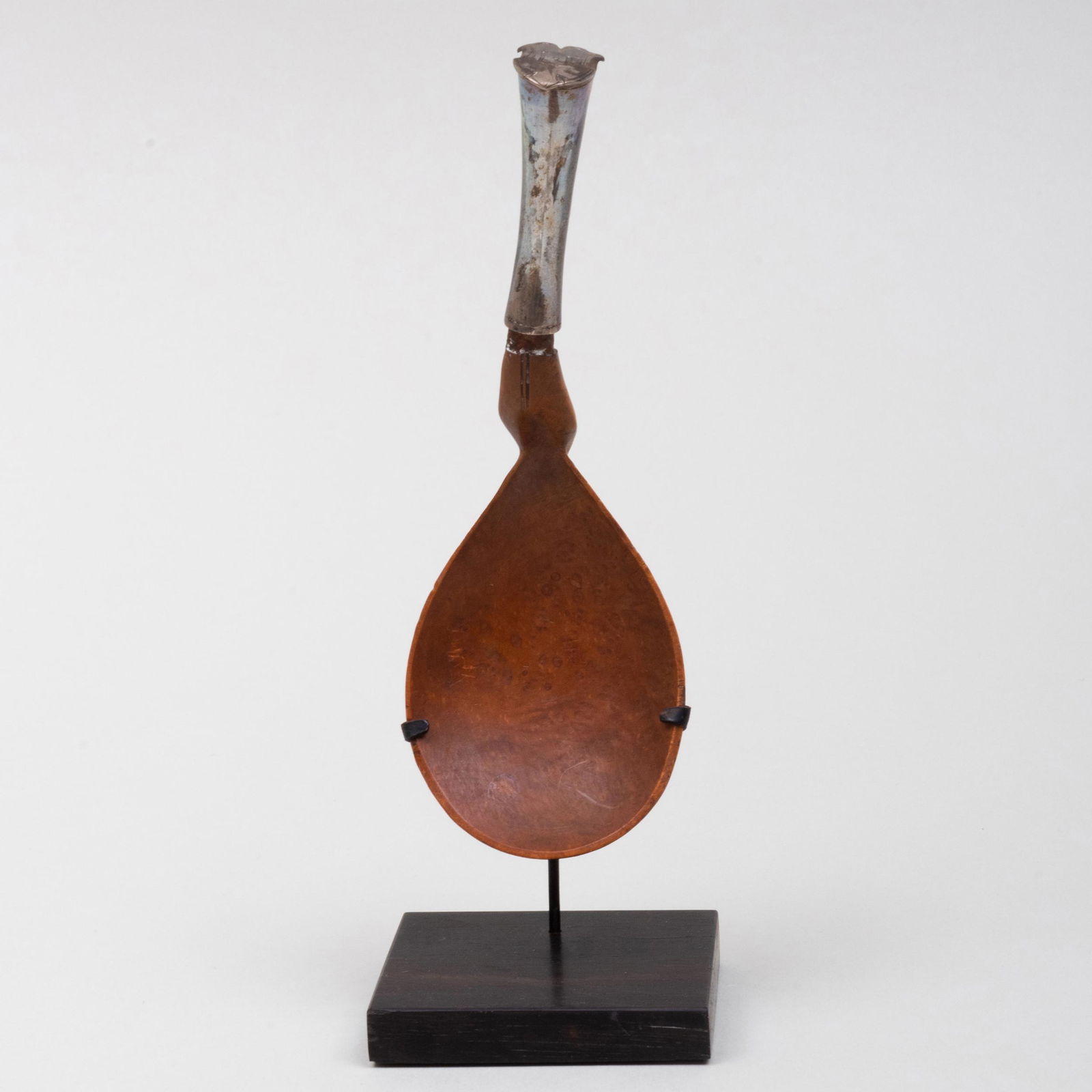 Native American Metal-Mounted Burwood Spoon: Native American Metal-Mounted Burwood Spoon Now raised on a stand. The initials "L. P." on the handle. 6 3/4 x 2 1/8 x 1 7/8 in. (overall).