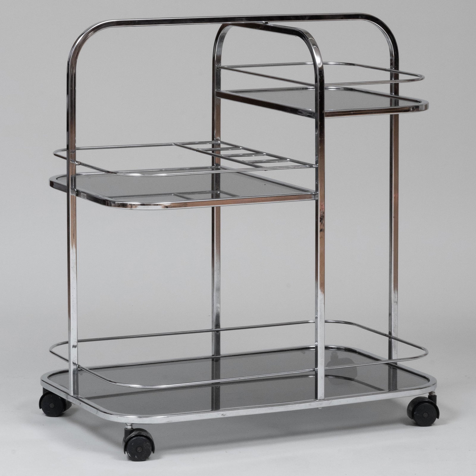 Modern Chrome and Smoked Glass Bar Cart: Modern Chrome and Smoked Glass Bar Cart Raised on casters. 32 1/2 x 29 x 19 1/4 in. Property from the Collection of Patricia Altschul