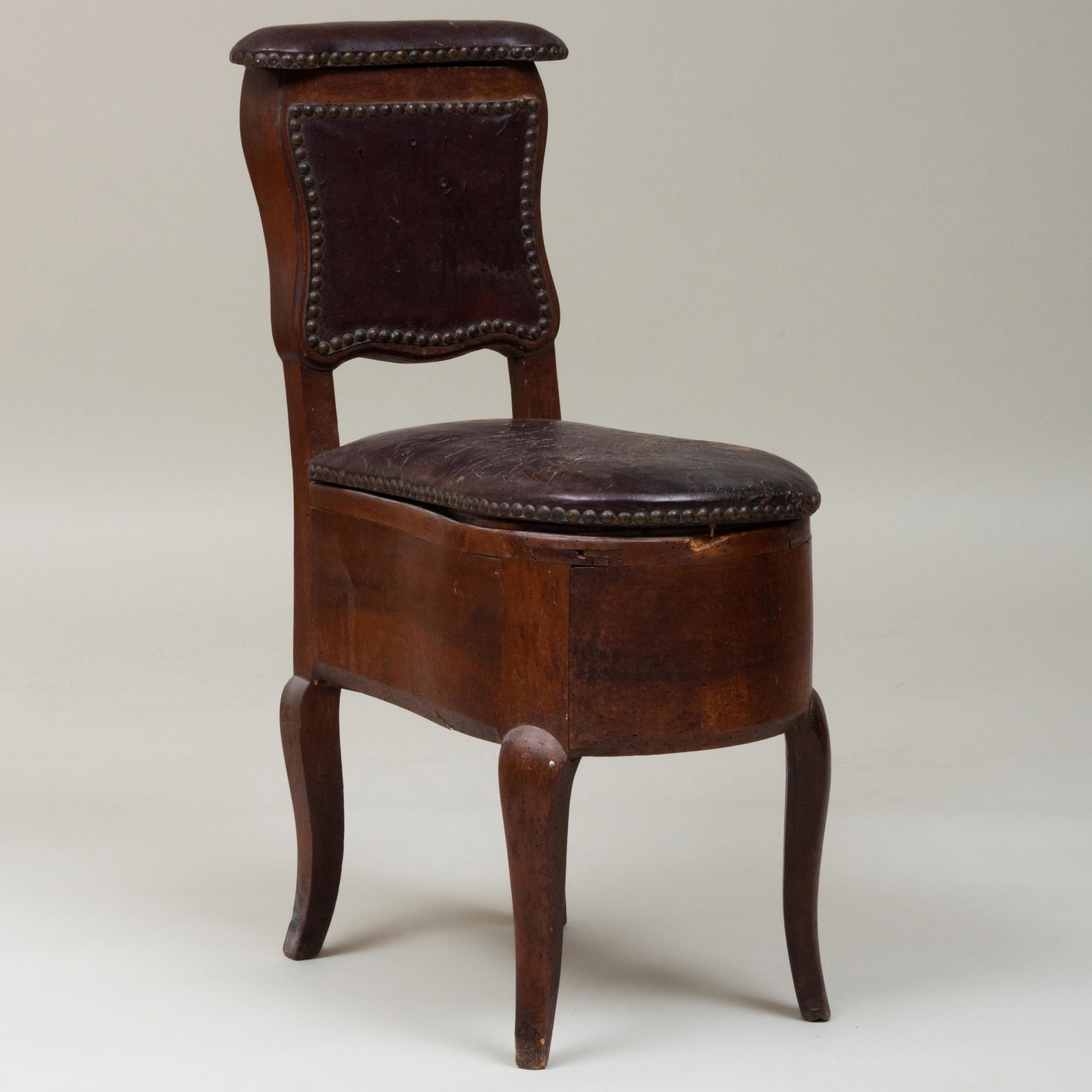 French Provincial Walnut and Leather Bidet: French Provincial Walnut and Leather Bidet 32 1/2 x 13 1/4 x 19 in. Height of seat 18 3/4 in. An Artist's Life: The Collection of Henry Koehler