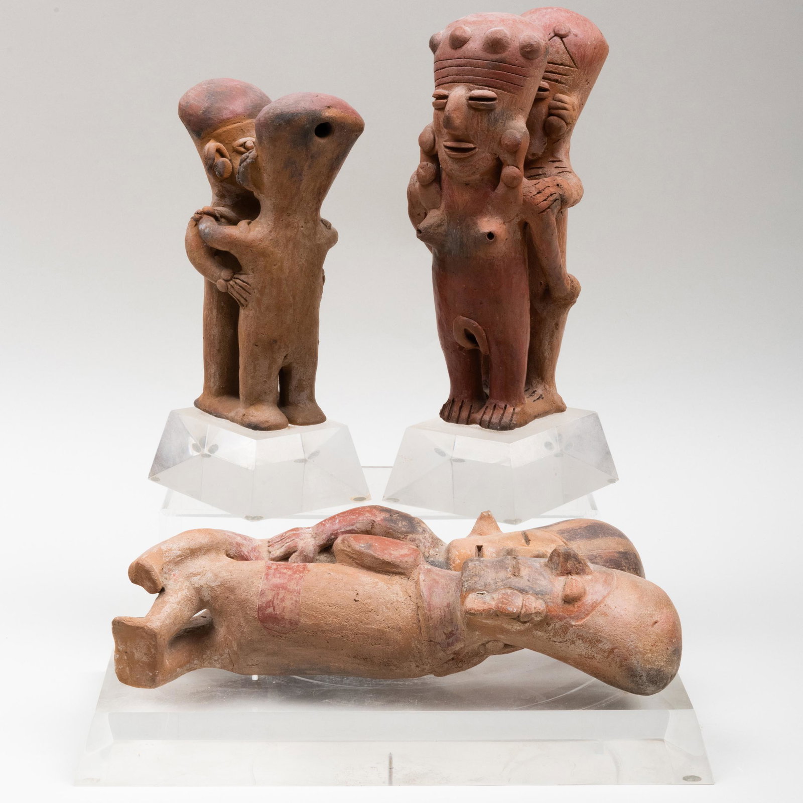 Three Pre-Colombian Erotic Pottery Figure Groups: Three Pre-Colombian Erotic Pottery Figure Groups Raised on lucite bases. The largest 5 x 14 x 7 1/4 in. An Artist's Life: The Collection of Henry Koehler