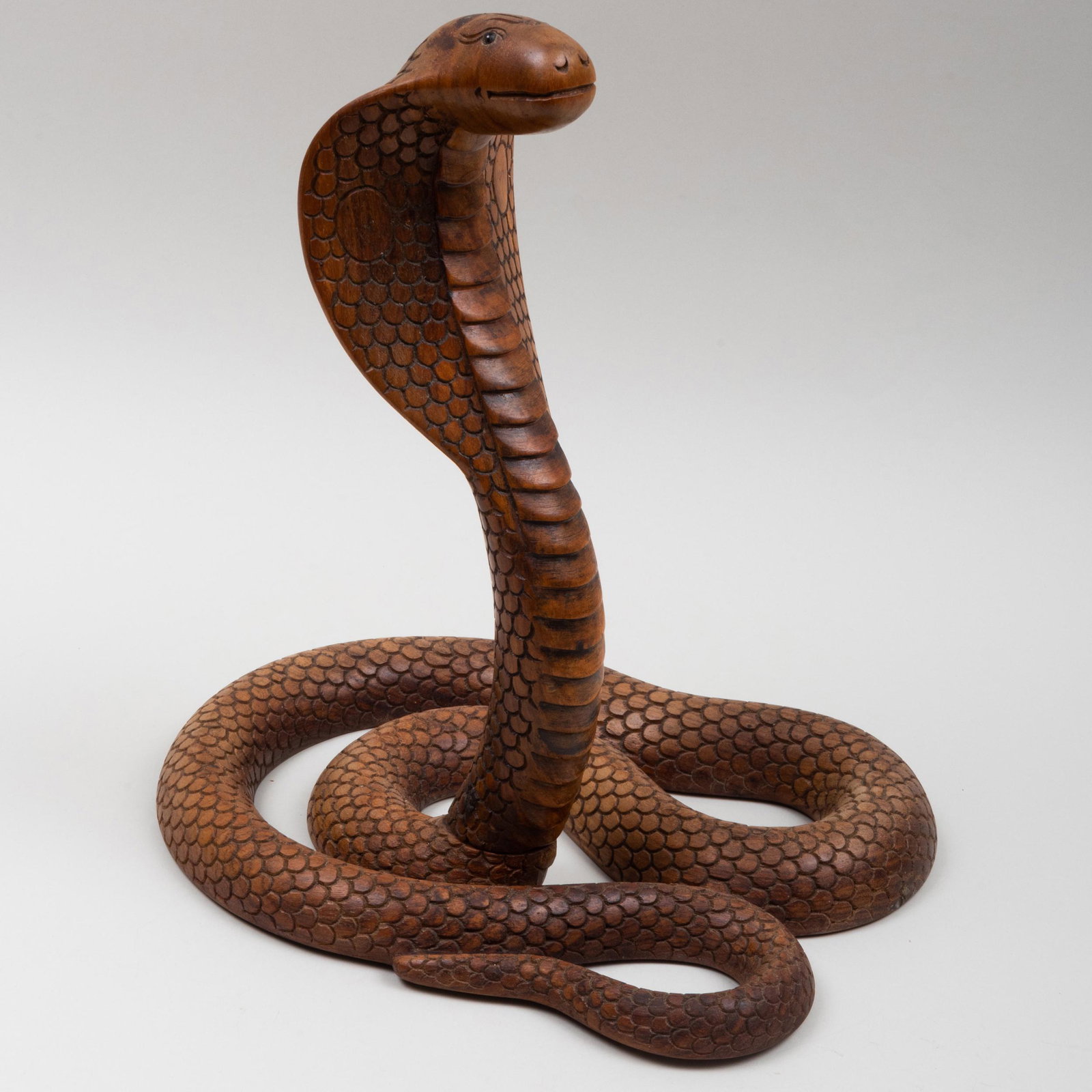 Carved Wood Model of a Coiled Cobra: Carved Wood Model of a Coiled Cobra Inset with glass eyes. 15 x 10 x 13 in. An Artist's Life: The Collection of Henry Koehler