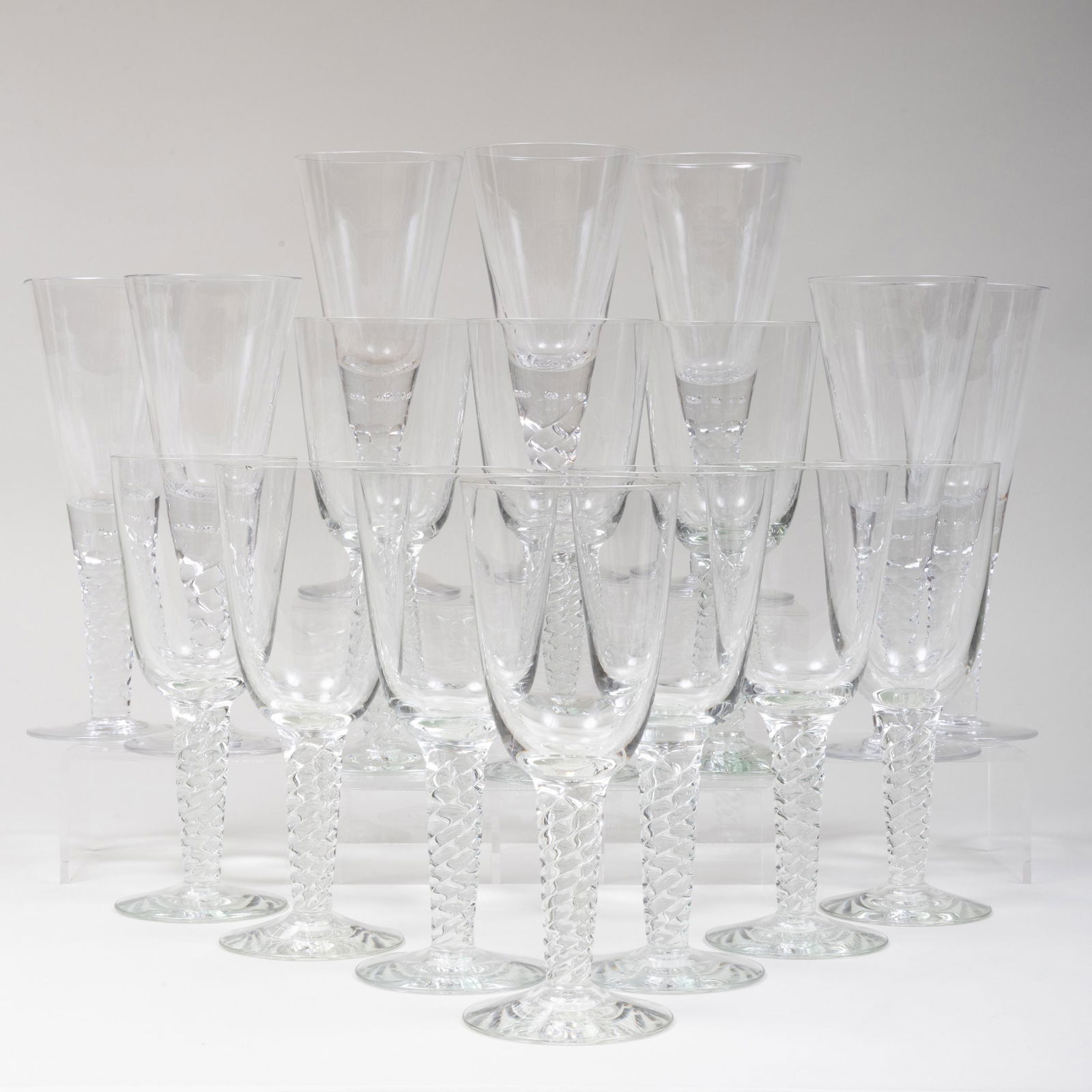 Set of Ten Large Goblets with Twist Stems and a Set of: Set of Ten Large Goblets with Twist Stems and a Set of Seven Large Goblets with Faceted Stems Unmarked. The twist 10 in. high, the facet 11 in. high.