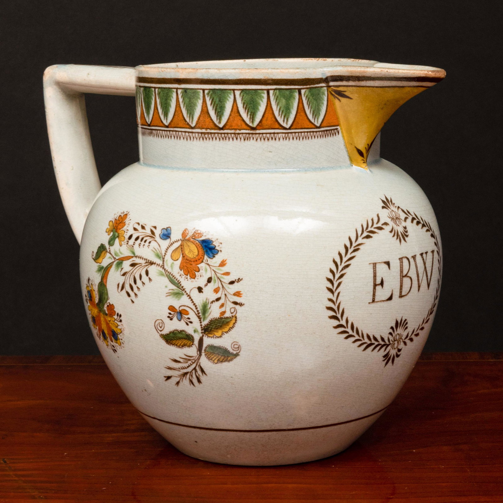 English Pearl Glazed Earthenware Monogrammed Syphoning: English Pearl Glazed Earthenware Monogrammed Syphoning Puzzle Jug Unmarked. 6 1/4 x 8 x 5 1/2 in. Property from the Collection of Wynn A. and Elizabeth F. Sayman