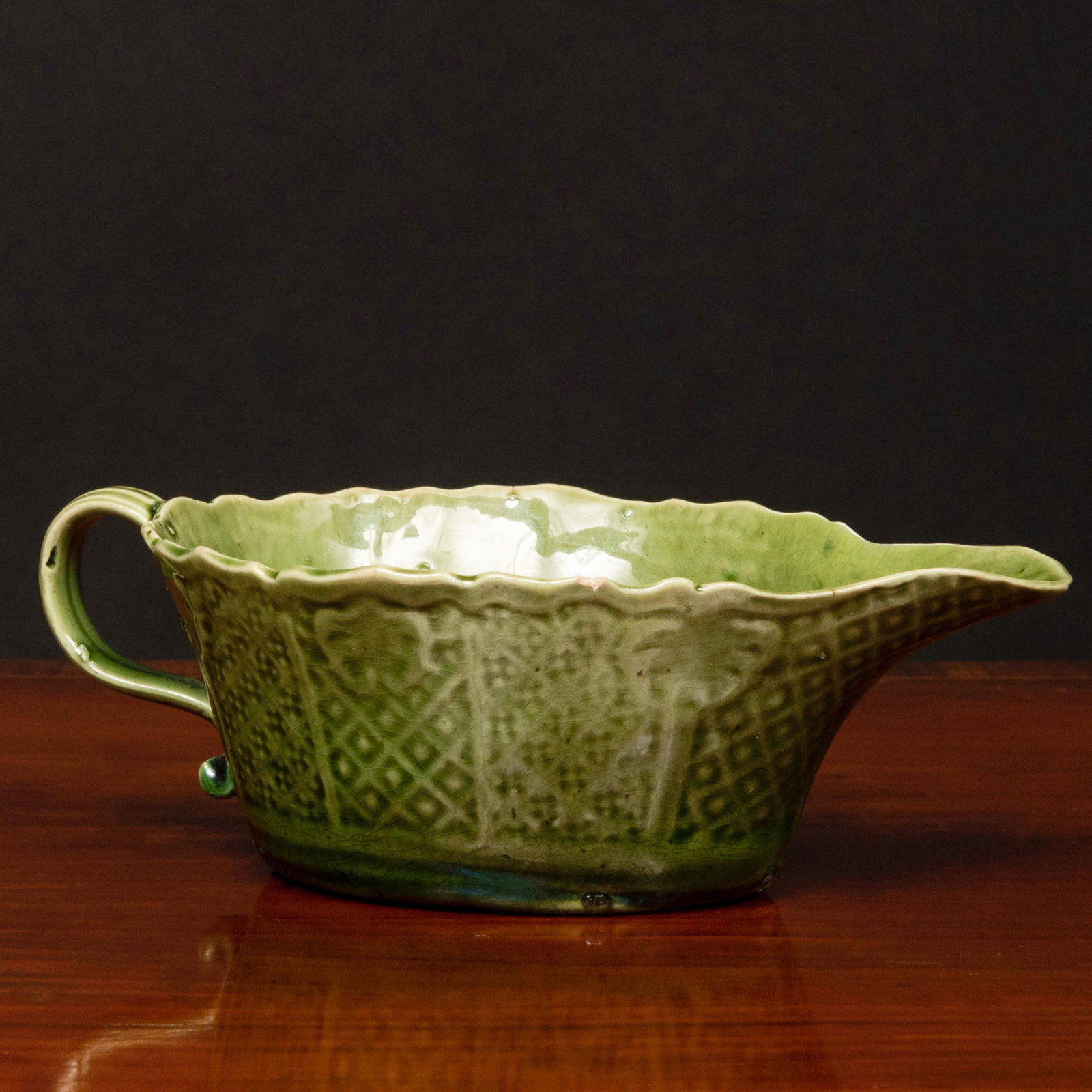 Small Staffordshire Green Glazed Earthenware Sauceboat: Small Staffordshire Green Glazed Earthenware Sauceboat Unmarked. 1 3/4 x 5 3/8 x 3 in. Property from the Collection of Wynn A. and Elizabeth F. Sayman