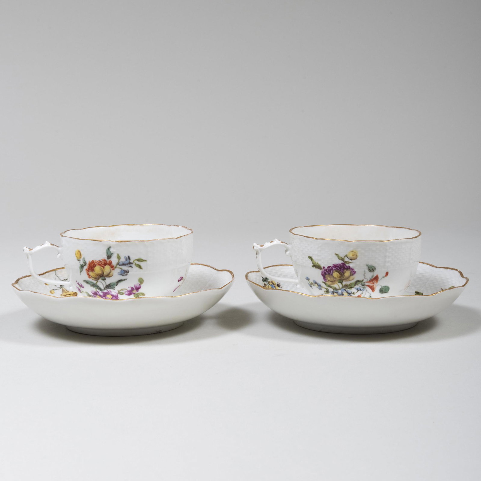 Pair of Meissen Porcelain Cups and Saucers: Pair of Meissen Porcelain Cups and Saucers Blue blue crossed sword mark. The cup 2 in. high, the saucer 5 3/8 in. diam.
