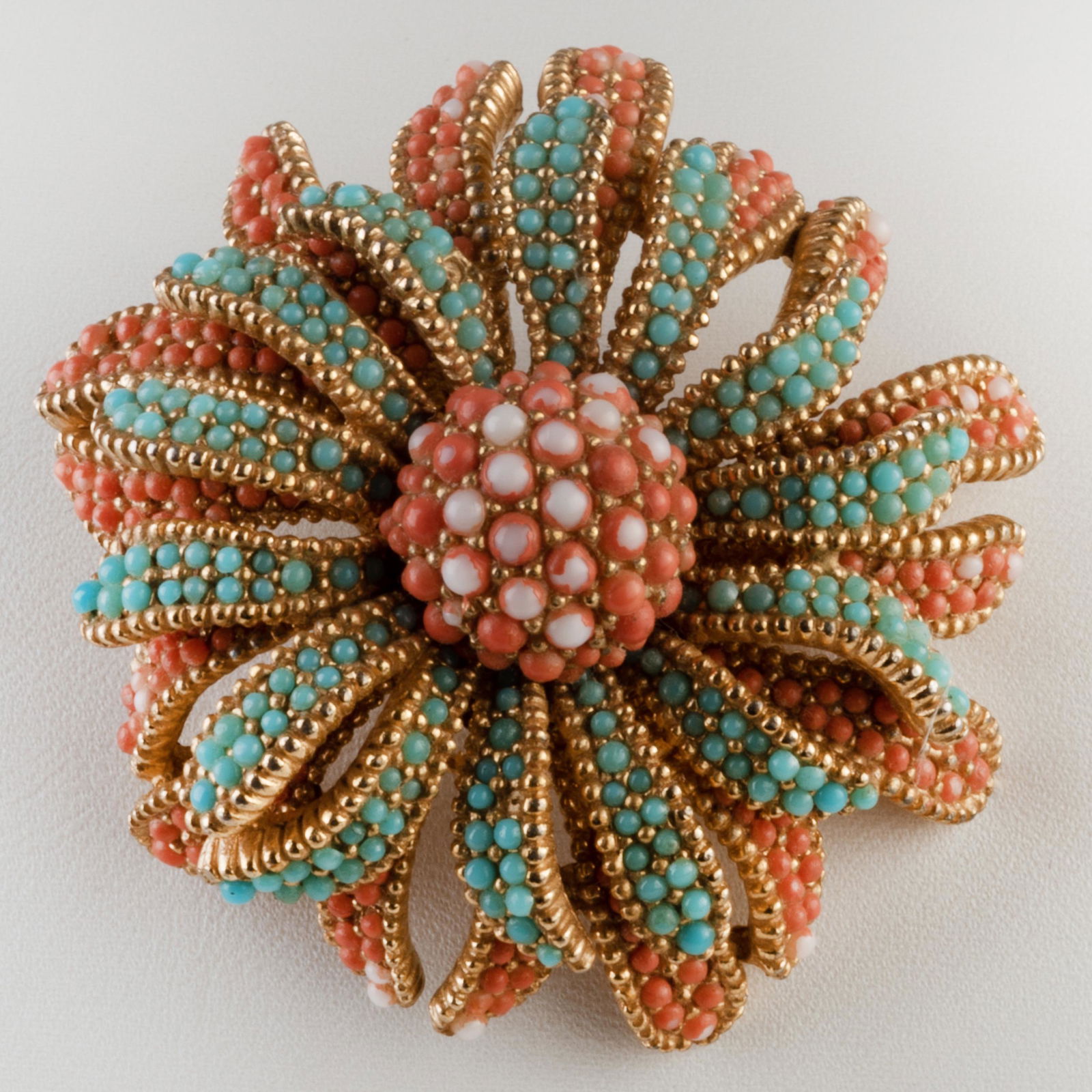 Ciner Faux Turquoise and Coral Floral Brooch: Ciner Faux Turquoise and Coral Floral Brooch Signed 'Ciner'; together with a black bangle bracelet. Brooch 2 in. diam., bangle 2 3/4 in. inside diam.