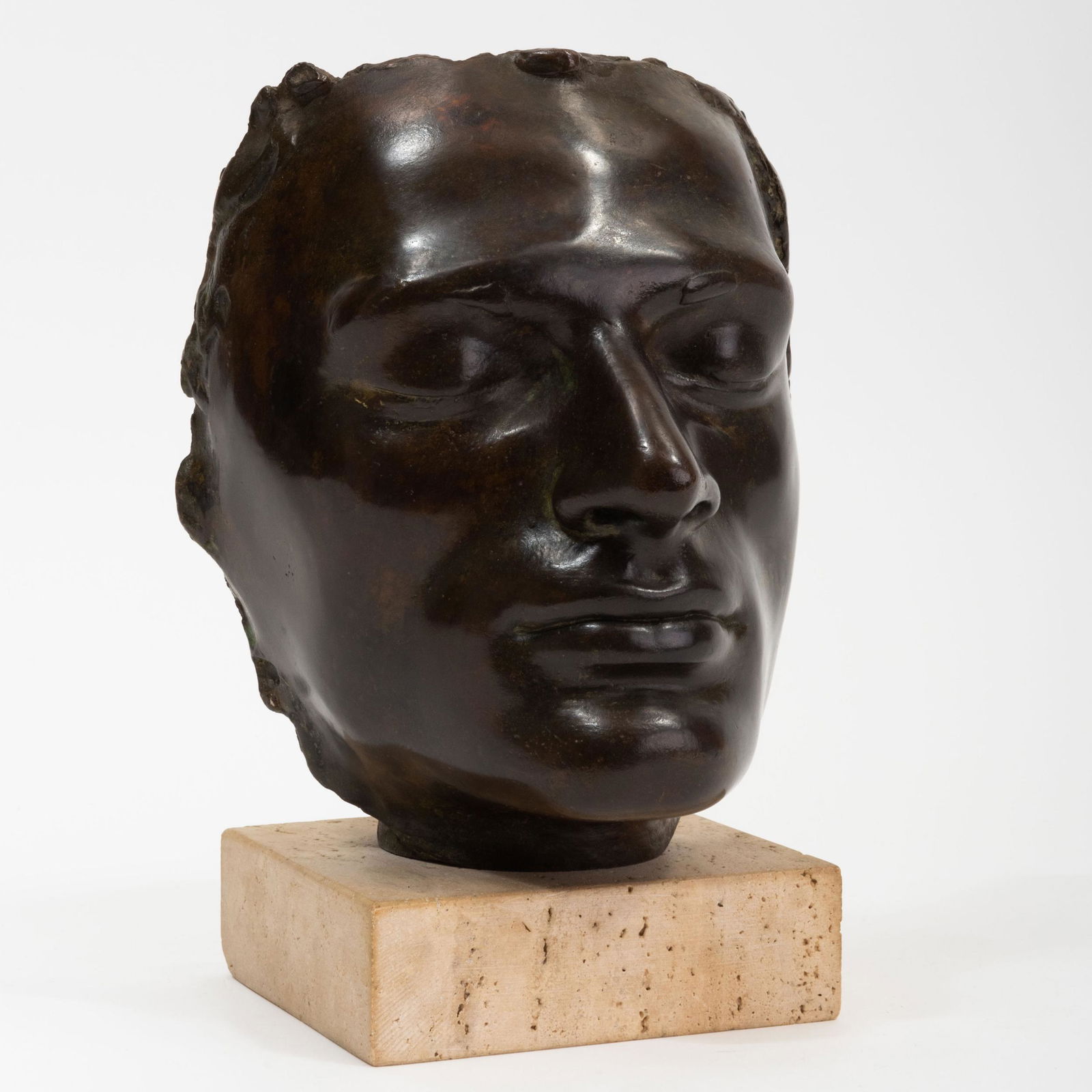 Hirsch Brenowitz: Face: Hirsch Brenowitz: Face Bronze, 1987, signed 'Hirsch Brenowitz' and dated on the reverse, on a travertine base. 9 1/2 x 7 x 6 in. Works from the Collection of Dick Polich and the Polich Tallix Fine Art
