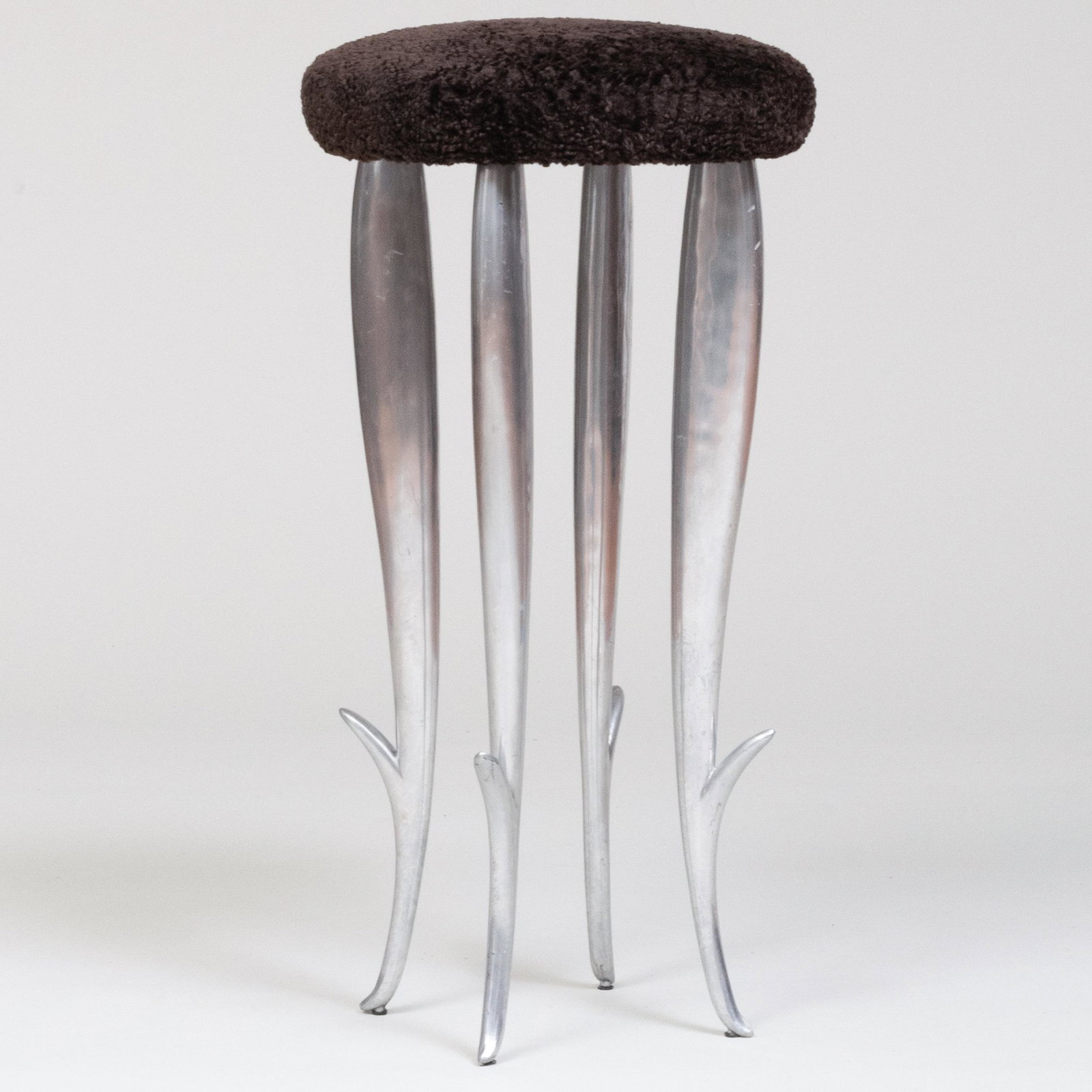 Philippe Starck Cast Aluminum and Lambs' Wool Stool, Stamped: 'Starck.XO'.: Philippe Starck Cast Aluminum and Lambs' Wool Stool, Stamped: 'Starck.XO'. 29 1/2 x 14 1/2 in. diam. Masterfully Decorated Homes: Property from the Collection of the Late Douglas S. Cramer, River Hous