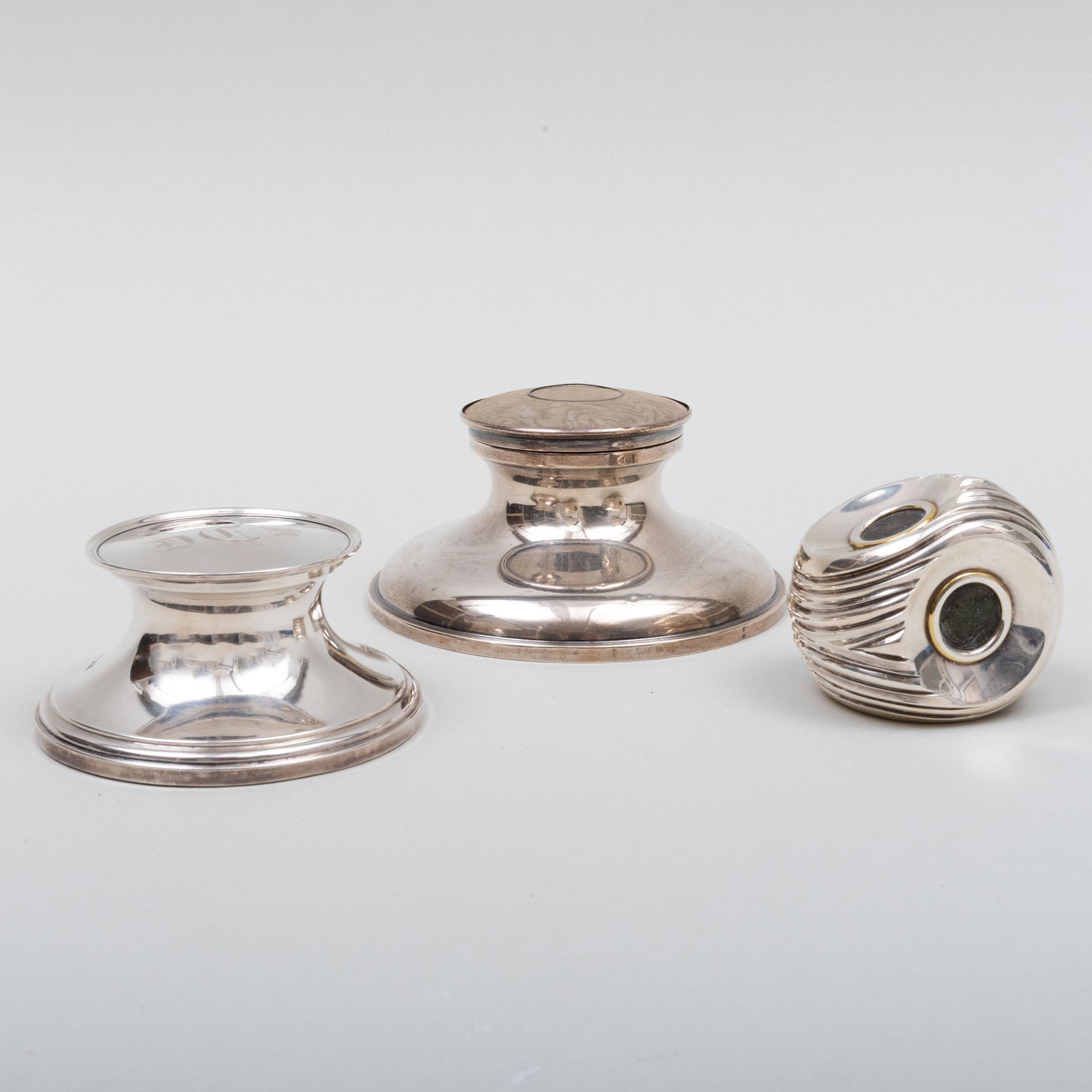 Group of Silver Desk Accessories: Group of Silver Desk Accessories Comprising: A Bulgari paperweight inset with antique coins An inkwell with glass liner, mark of Charles & Richard Comyns, London, 1919 An inkwell, mark of William Comy