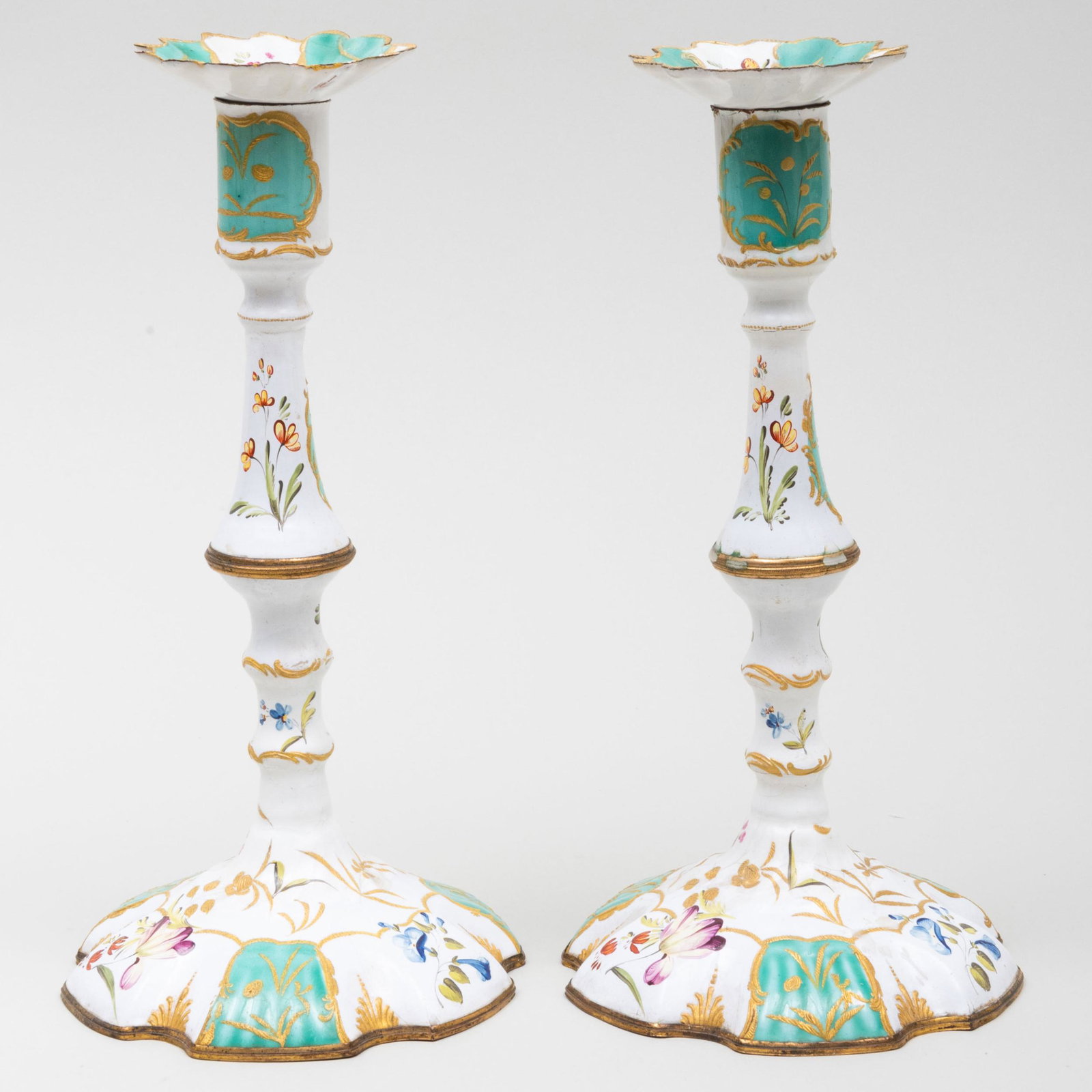 Pair of Staffordshire White and Green Enamel Candlesticks: Pair of Staffordshire White and Green Enamel Candlesticks 10 x 5 in. diam. Estate of Don F. Gaston, Greenwich, Connecticut One with applied label for D.M. & P. Manheim, NY.